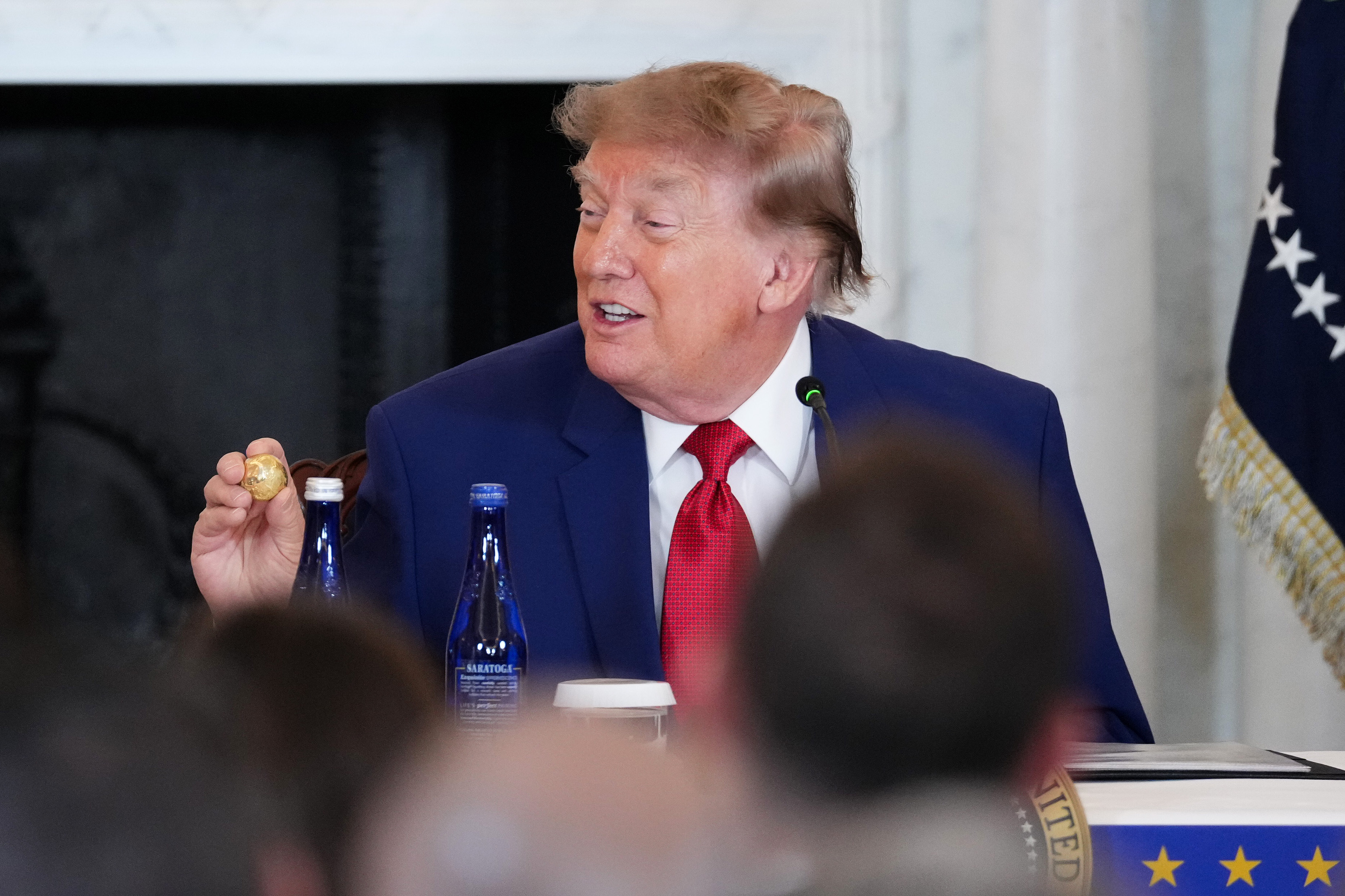 WASHINGTON, DC - AUGUST 07: U.S. President Donald Trump holds up a gold replica of a deep sea nodule given to him by Chairman of the American Ocean Minerals Tom Albanese during a roundtable on the American mining industry at the U.S. Department of State on August 07, 2026 in Washington, DC. Trump attended the event as his administration aims to secure additional supplies of critical minerals in an effort to replenish weapons stockpiles&nbsp;that have been depleted during the U.S. conflict with Iran.  (Photo by Eric Lee/Getty Images)