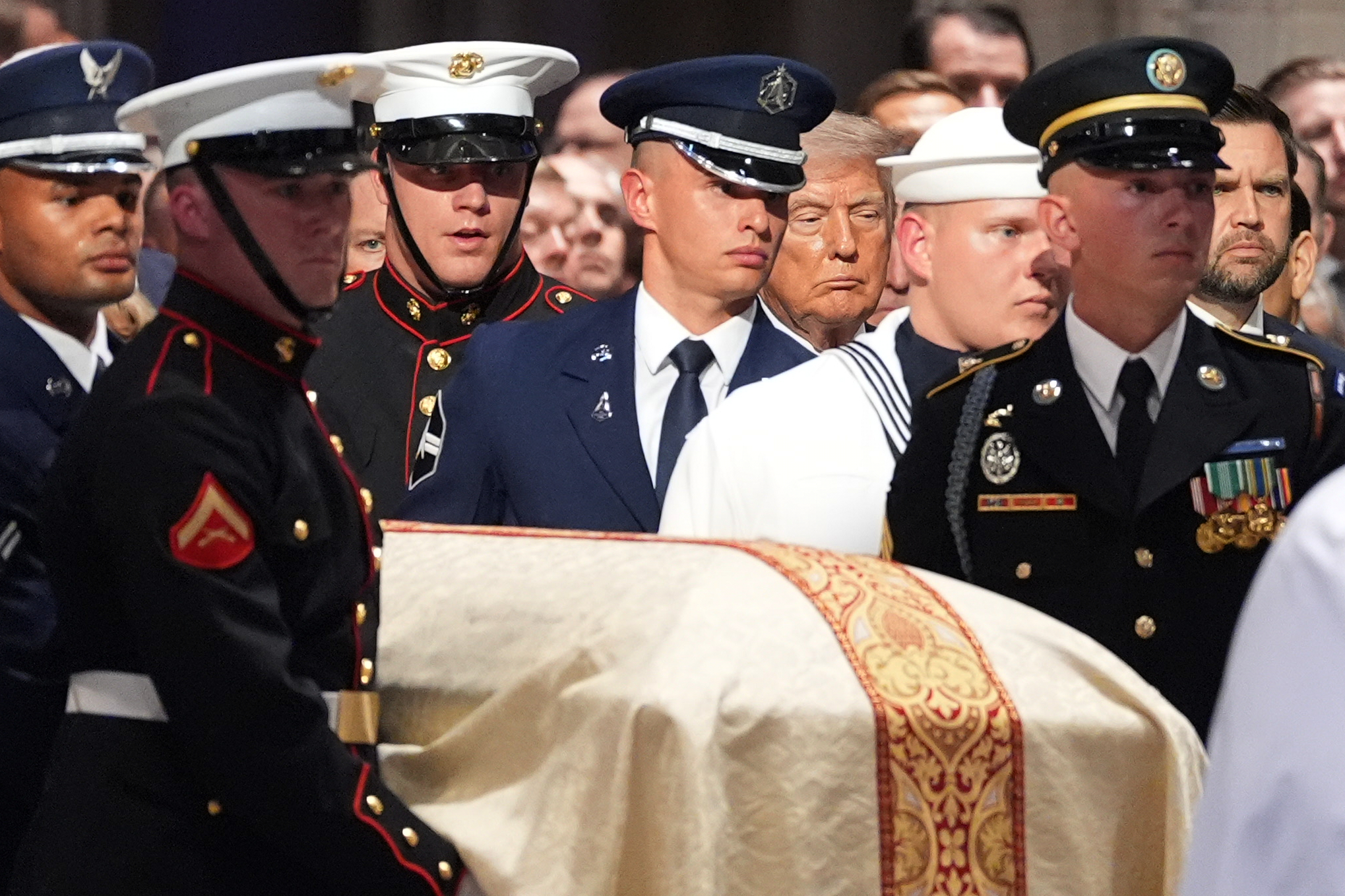 President Donald Trump watches as an Armed Forces Body Bearer Team moves the casket of Sen. Lindsey Graham, R-S.C., during a funeral service at the Washington National Cathedral, Tuesday, July 28, 2026, in Washington. (AP Photo/Alex Brandon)