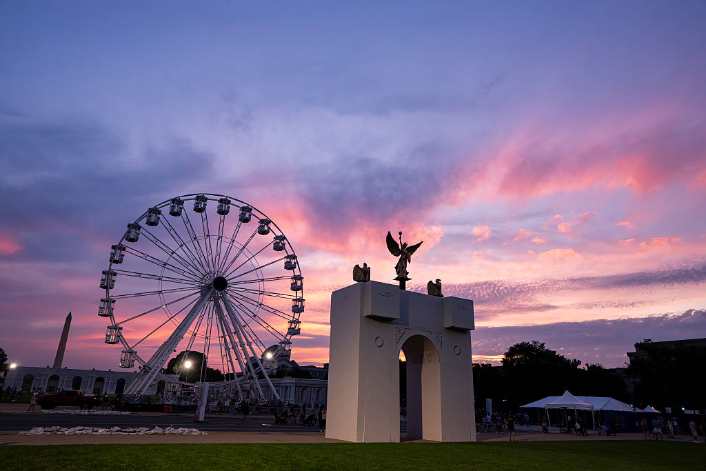 WASHINGTON, DC - JUNE 25: The sun sets behind a replica of the planned Triumphal Arch and the 110-foot
