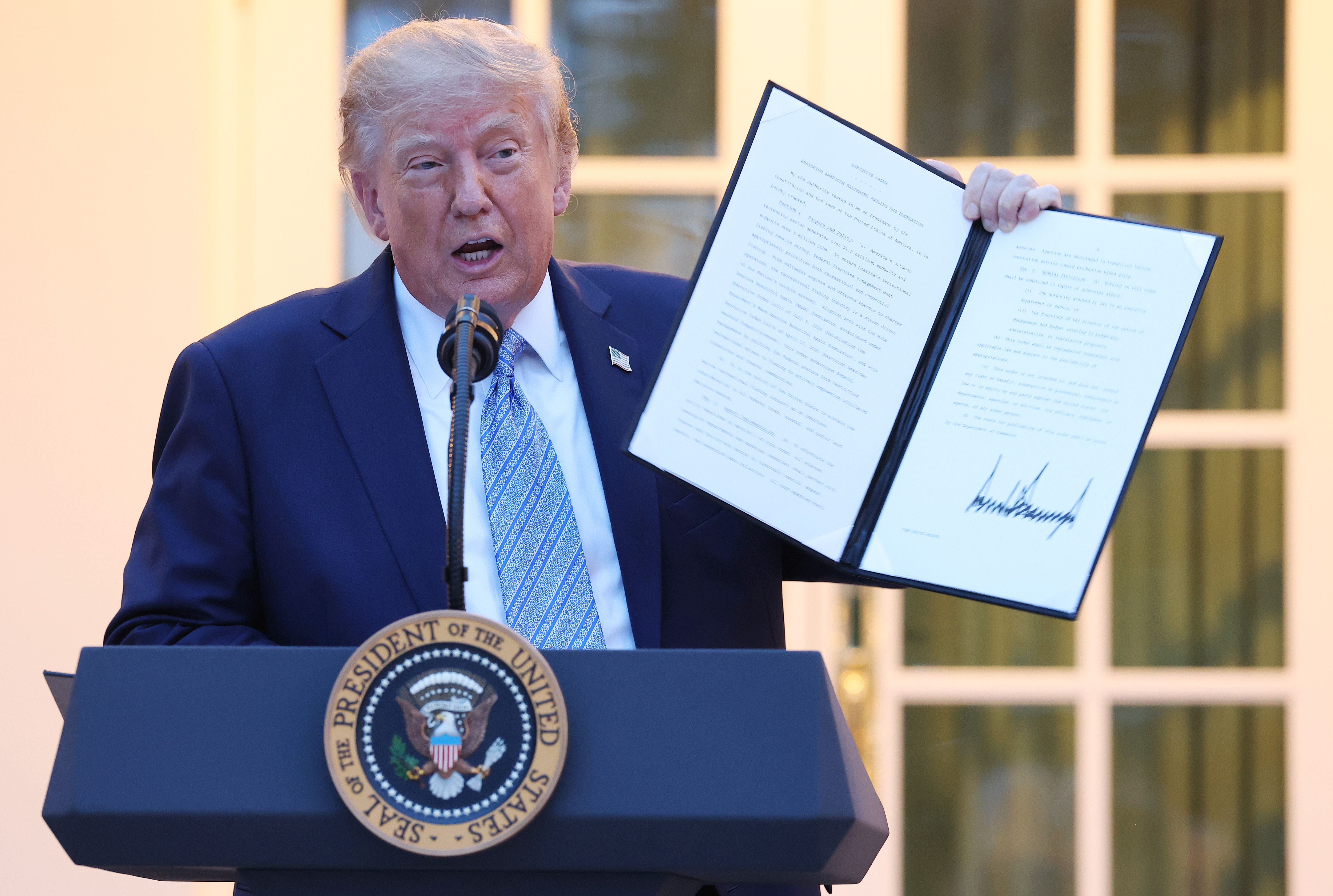 President Donald Trump displays a signed executive order while speaking at a dinner in the Rose Garden of the White House on September 17, 2026 in Washington, DC. Trump was hosting the dinner for hunters, anglers and outdoor industry leaders after signing orders expanding hunting and fishing on public lands and reversing certain restrictions enacted in the Biden administration. (Photo by Anna Moneymaker/Getty Images)