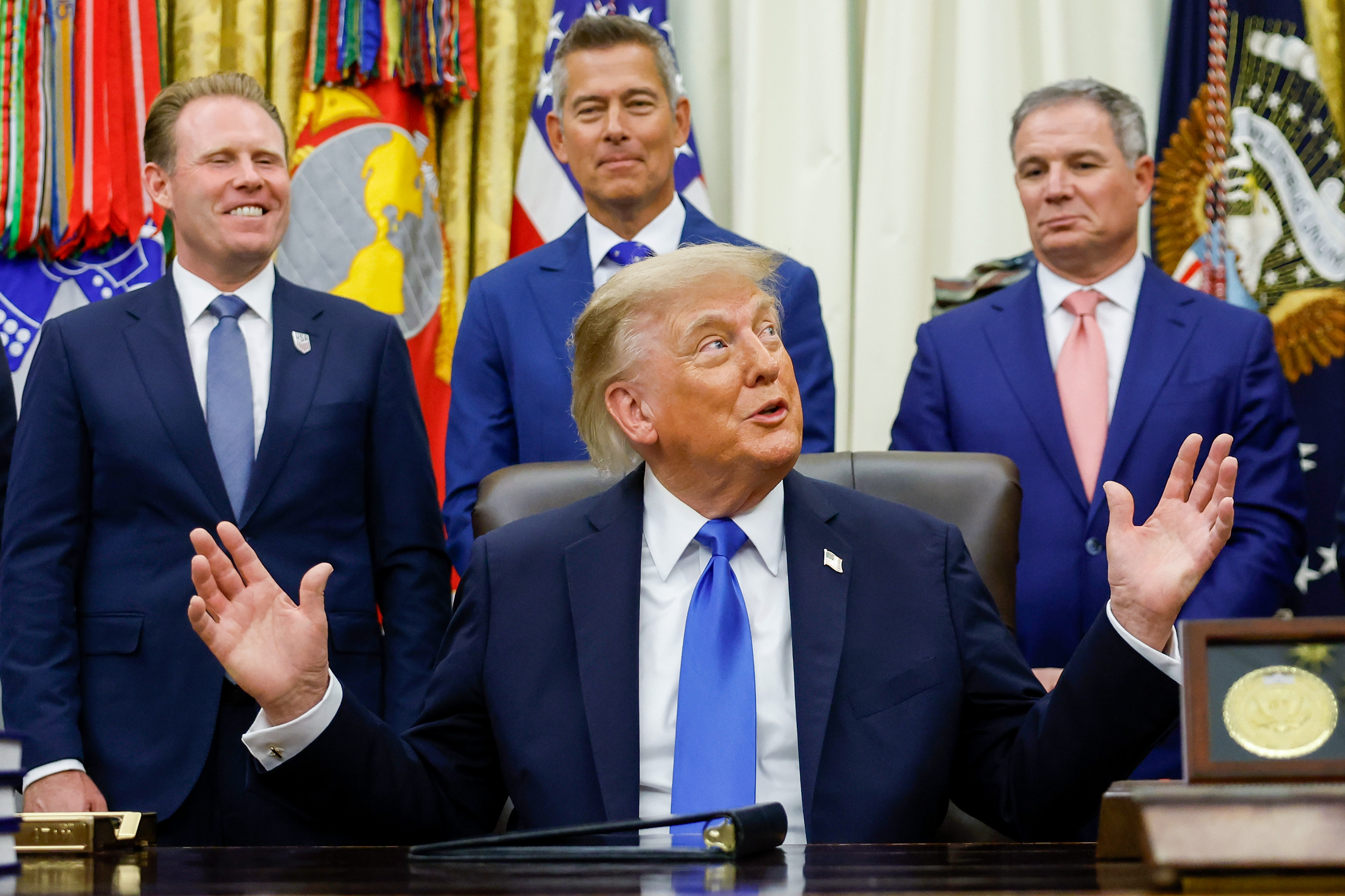 WASHINGTON, DC - SEPTEMBER 02: U.S. President Donald Trump (C) reacts as he joined by (L-R) Executive Director of the White House Task Force on the FIFA World Cup 2026 Andrew Giuliani, U.S. Transportation Secretary Sean Duffy and President and CEO of U.S. Travel Association Geoff Freeman during a meeting with U.S. travel executives in the Oval Office of the White House on September 02, 2026 in Washington, DC. President Trump met with executives from travel companies including American Airlines, Marriott, MGM Resorts, Carnival, Caesars Entertainment, Hard Rock International, Venetian, and Raffles & Fairmont. (Photo by Kevin Dietsch/Getty Images)