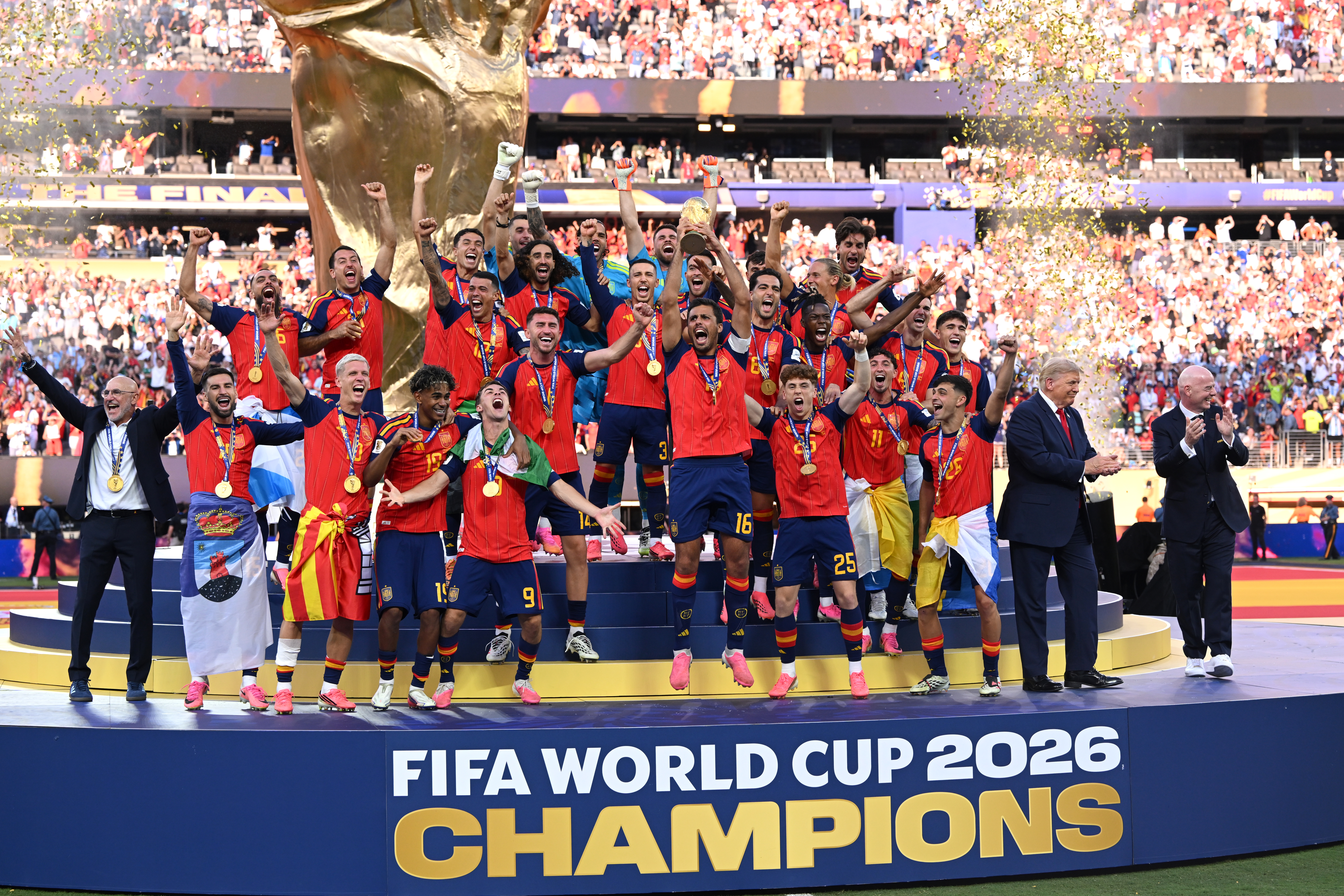 EAST RUTHERFORD, NEW JERSEY - JULY 19: Rodri #16 of Spain lifts the FIFA World Cup Winner’s Trophy alongside U.S. President Donald Trump and FIFA President Gianni Infantino after the team’s victory following during the FIFA World Cup 2026 Final match between Spain and Argentina at New York New Jersey Stadium on July 19, 2026 in East Rutherford, New Jersey. (Photo by David Ramos/Getty Images)