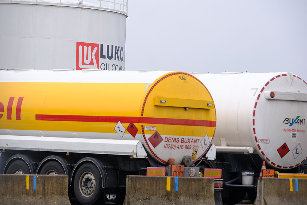 BRUSSELS, BELGIUM - NOVEMBER 15: Tanker trucks are waiting near the PJSC Lukoil Oil Company tank storage of Neder-Over-Heembeek are seen on November 15, 2025 in Brussels, Belgium. As of November 2025, Lukoil is reeling under severe U.S. and Western sanctions, which have forced the company to divest international assets and halt operations at major projects, including Iraq’s West Qurna-2 oil field. Facing a November 21 deadline to wind down foreign operations, Lukoil struggles to find buyers—even among major partners like India and China—and recently saw a $22 billion asset sale to Gunvor collapse. Sanctions from the U.S. and UK have also disrupted its activities in Finland, Bulgaria, and other key regions. The company is now urgently seeking buyers for its overseas assets, including European refineries and stakes in oilfields across Kazakhstan, Iraq, Ghana, and Nigeria, as pressure mounts from governments and potential investors like Carlyle. (Photo by Thierry Monasse/Getty Images)