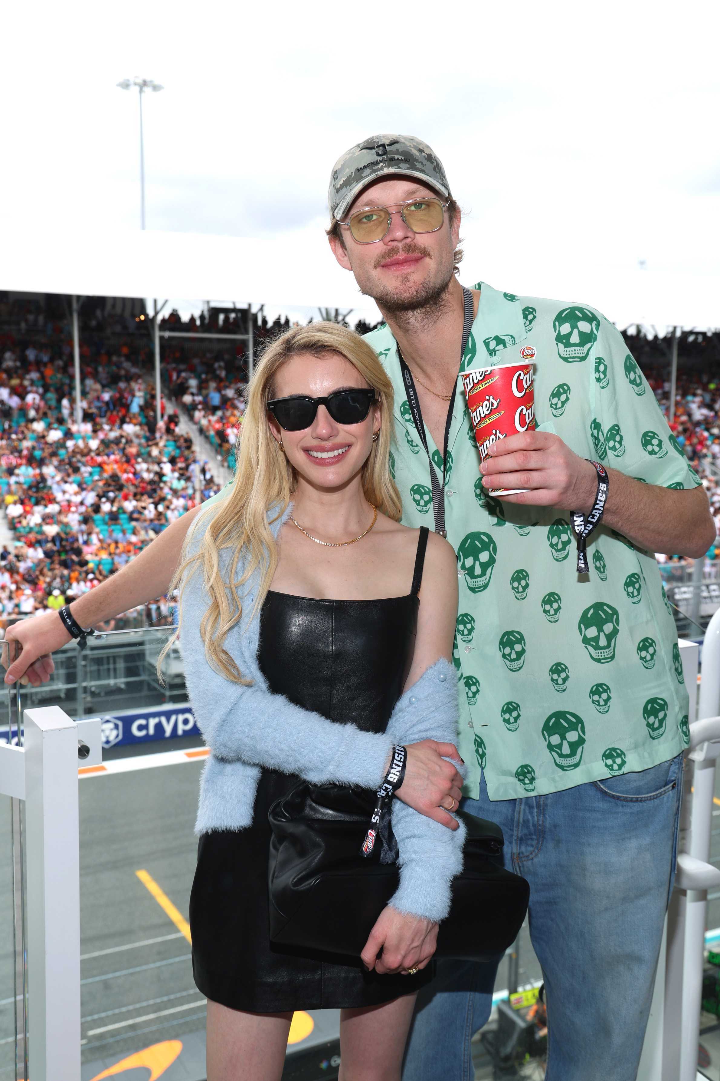 Emma Roberts and Cody John attend the Celebrity Friends For F1 Miami Grand Prix Race hosted by Raising Cane's Owner Todd Graves at Miami International Autodrome on May 03, 2026 in Miami, Florida.