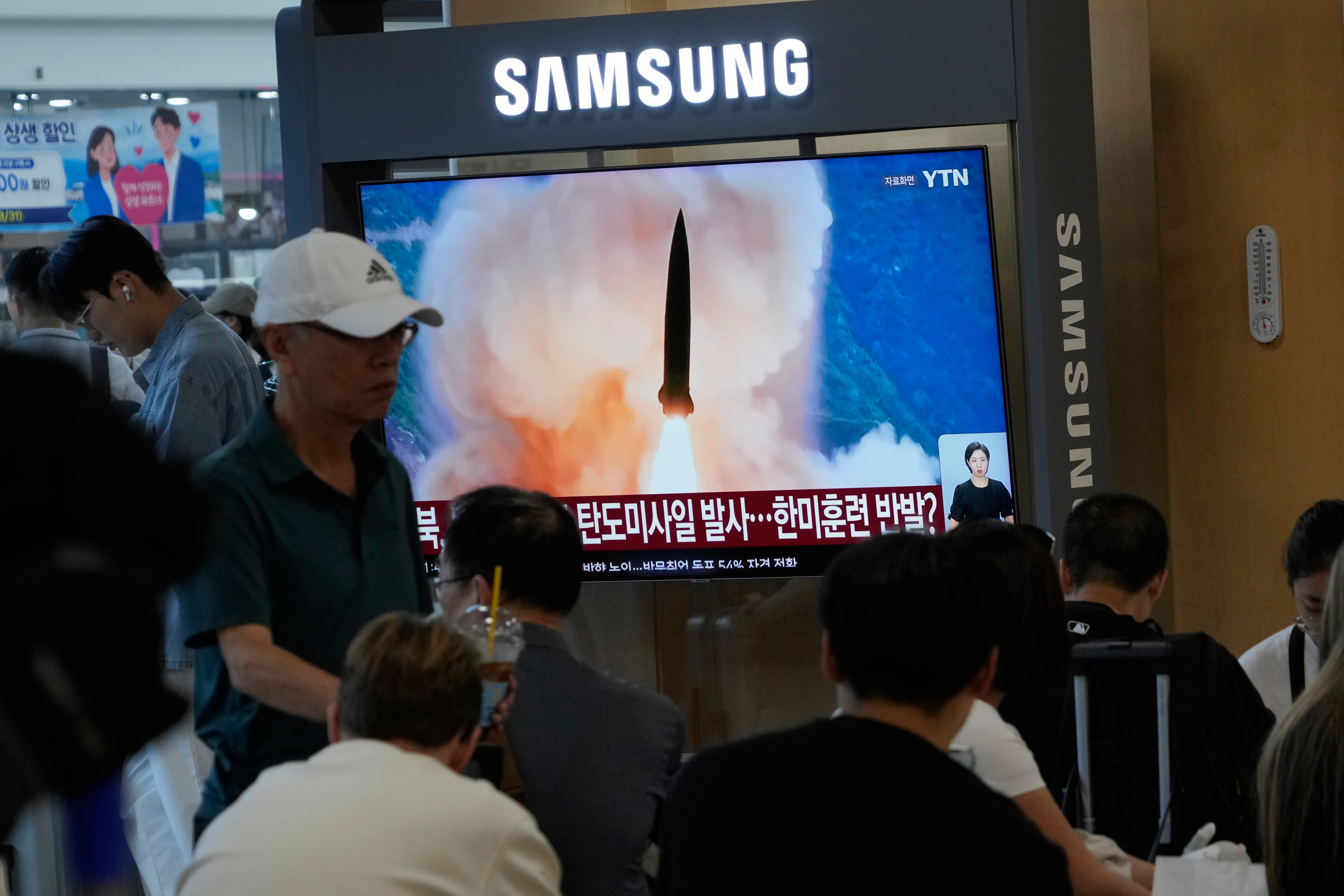 A TV screen shows a file image of North Korea's missile launch during a news program at Seoul Railway Station in Seoul, South Korea, Wednesday, Aug. 12, 2026. (AP Photo/Ahn Young-joon)