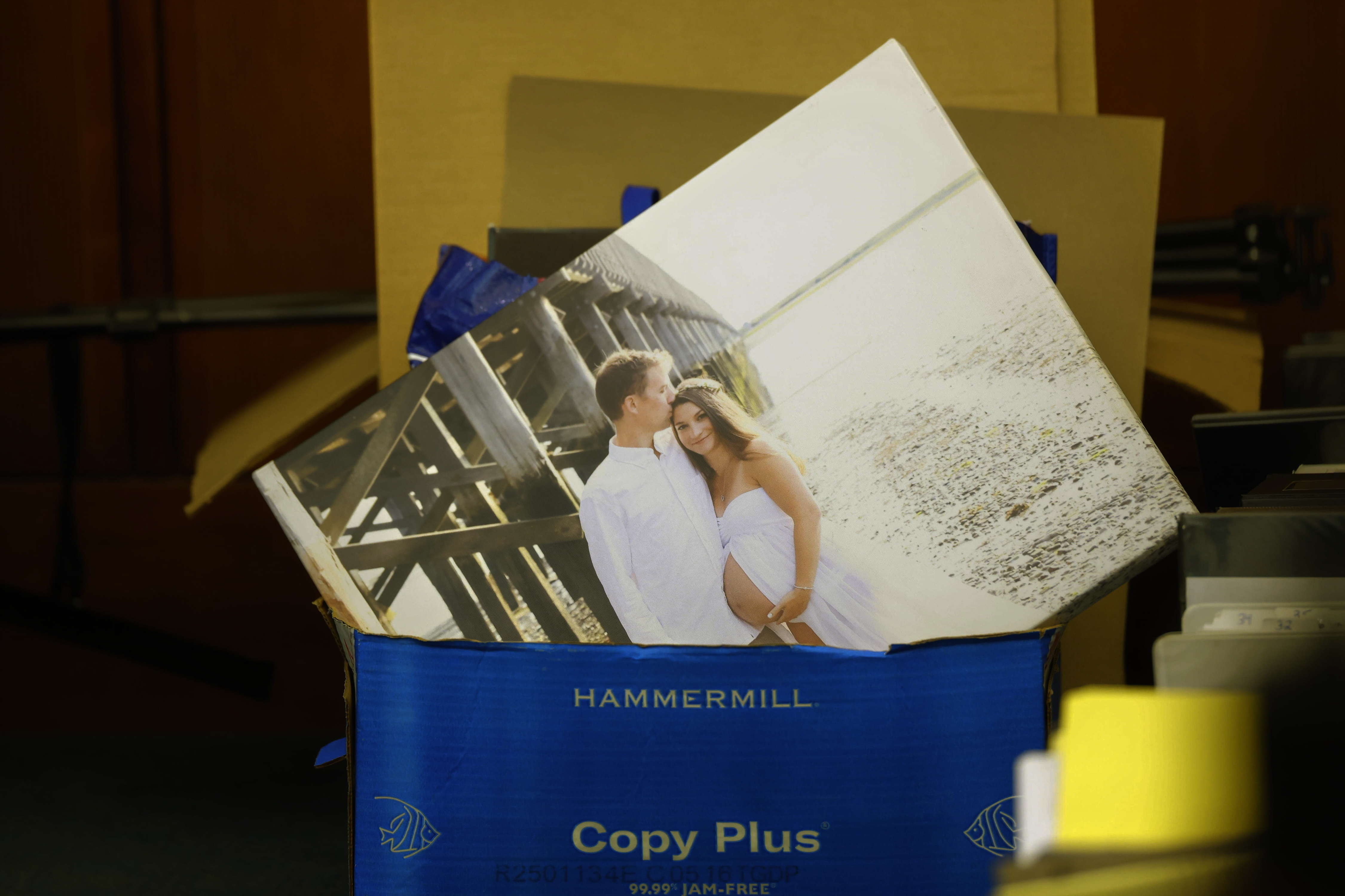 A wedding photo is seen in a bin of papers during the murder trial for Lindsay Clancy at Plymouth Superior Court in Plymouth, Mass., on Thursday, July 30, 2026. (CJ Gunther/The Boston Herald via AP, Pool)