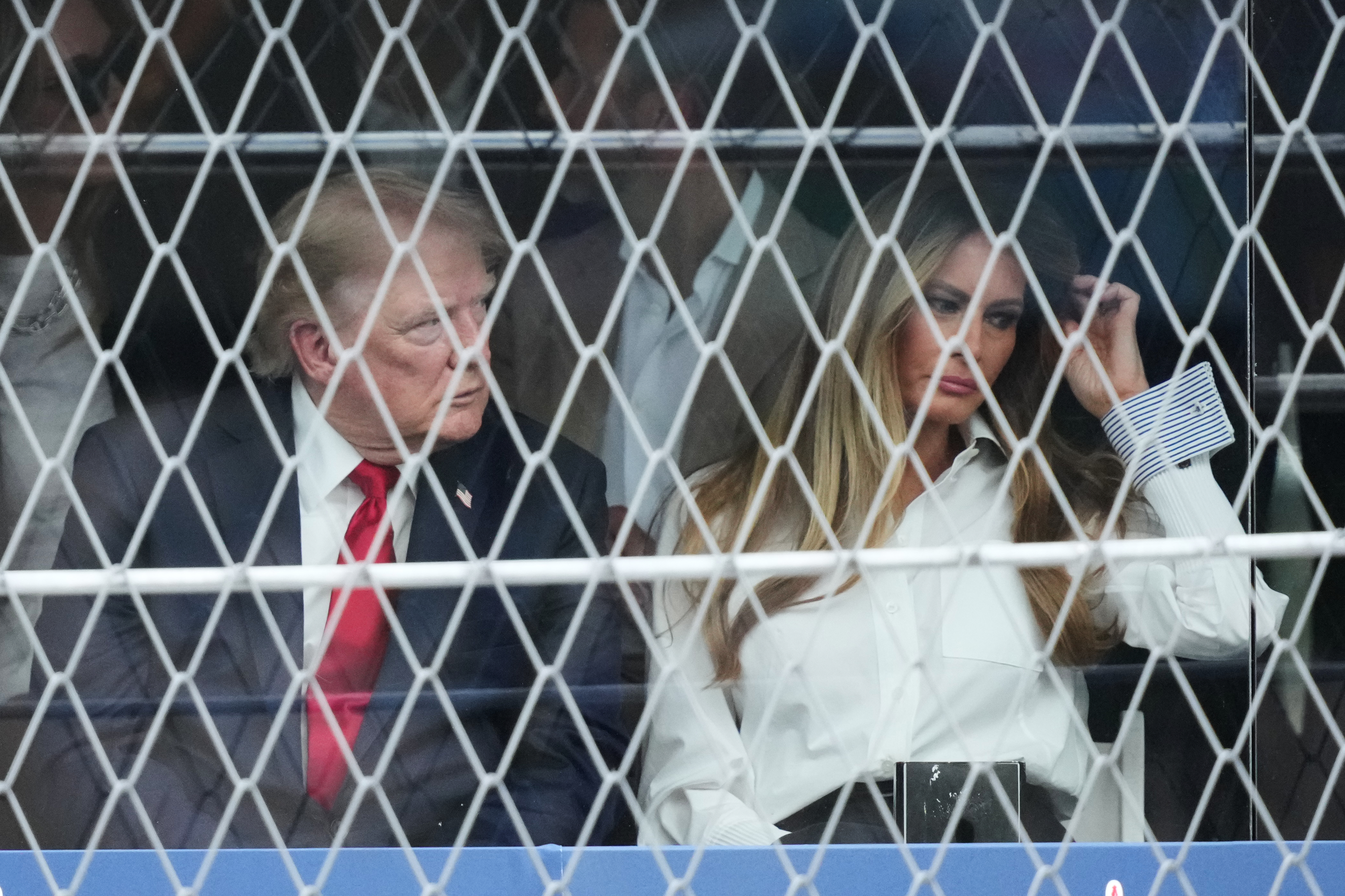 President Donald Trump and first lady Melania Trump watch the IndyCar Freedom 250 Grand Prix auto race in Washington, Sunday, Aug. 23, 2026. (AP Photo/Alex Brandon)