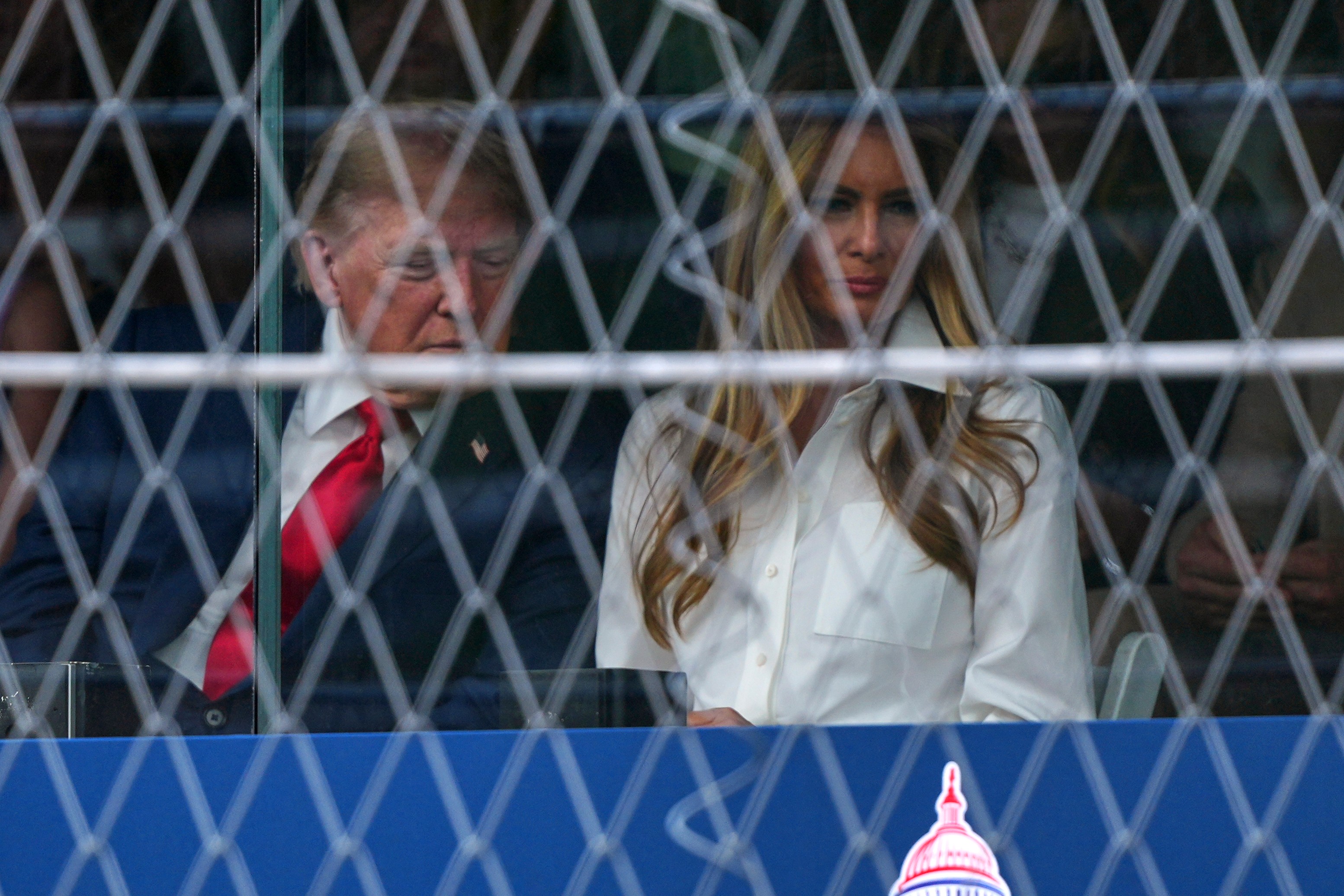President Donald Trump, left, speaks with first lady Melania Trump as they watch the IndyCar Freedom 250 Grand Prix auto race, Sunday, Aug. 23, 2026, in Washington. (AP Photo/Julia Demaree Nikhinson)