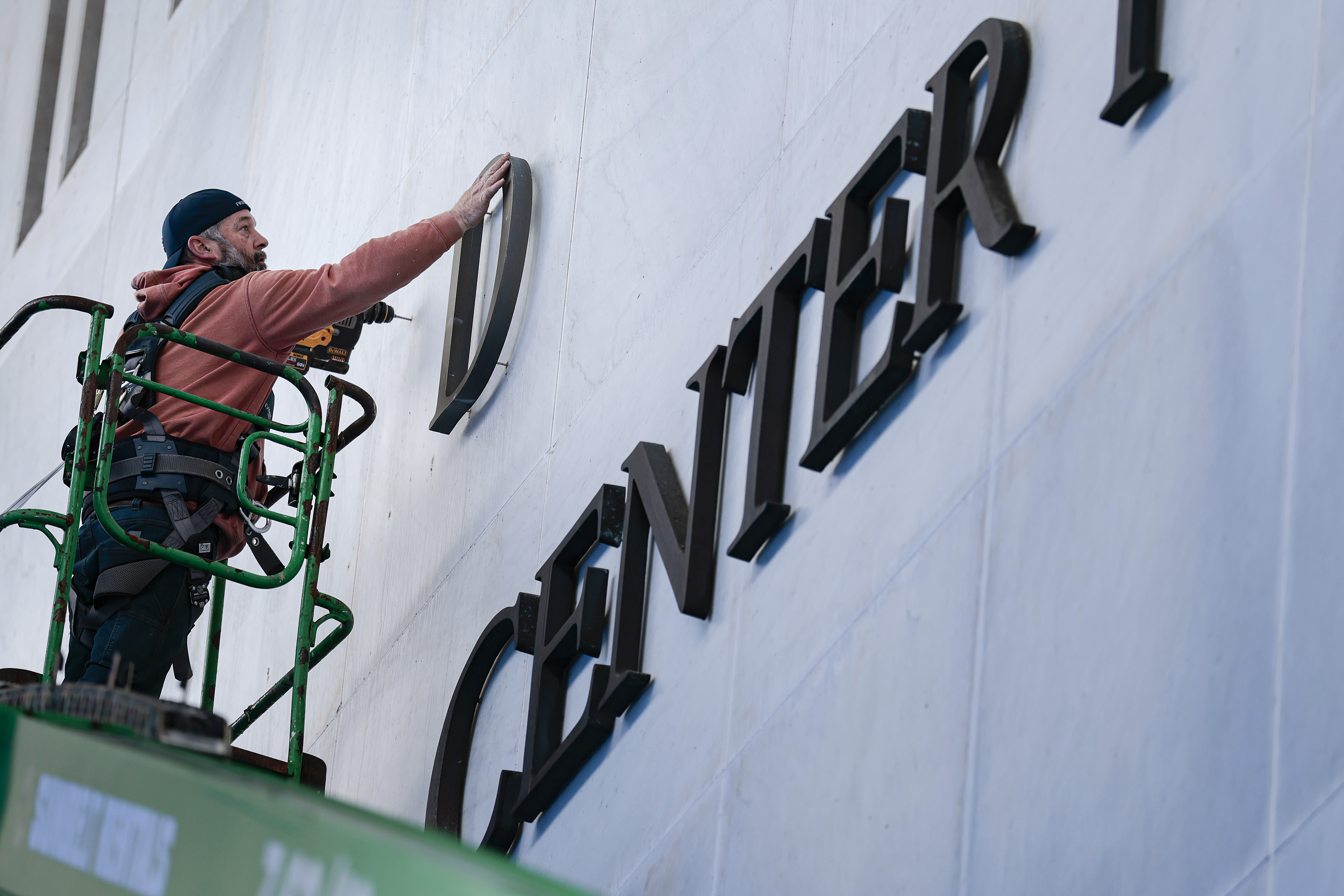 WASHINGTON, DC - DECEMBER 19: Workers begin adjusting the name of the “John F. Kennedy Memorial Center for the Performing Arts