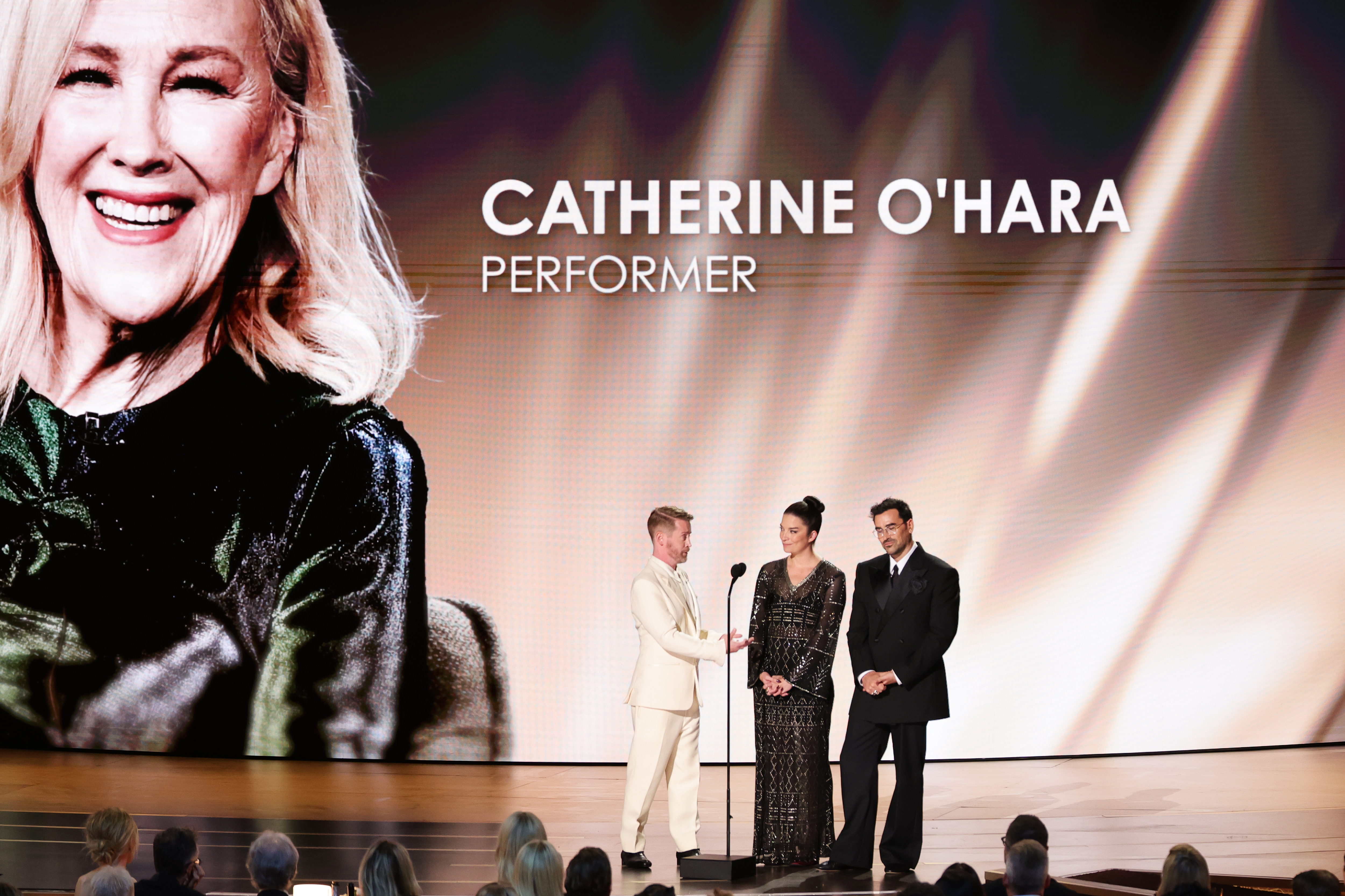 LOS ANGELES, CALIFORNIA - SEPTEMBER 14: (L-R) Macaulay Culkin, Annie Murphy, and Dan Levy speak onstage during the 78th Primetime Emmy Awards at Peacock Theater on September 14, 2026 in Los Angeles, California.  (Photo by Chloe Kern/WireImage)