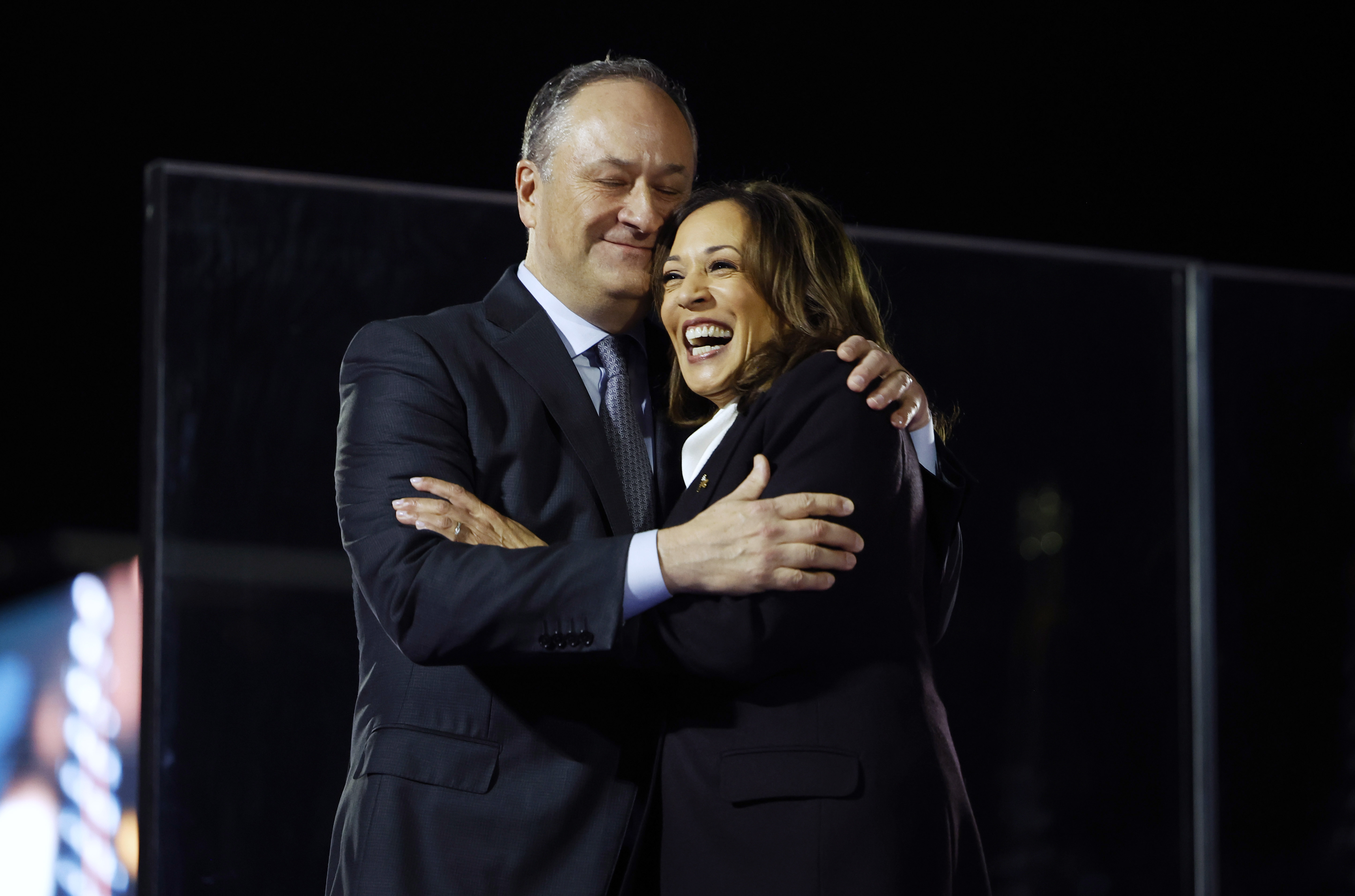 WASHINGTON, DC - OCTOBER 29: Democratic presidential nominee U.S. Vice President Kamala Harris is embraced by  Second gentleman Doug Emhoff during a campaign rally on the Ellipse on October 29, 2024 in Washington, DC. With one week remaining before Election Day, Harris delivered her “closing argument,” a speech where she outlined her plan for America and urged voters to “turn the page” on Republican presidential nominee, former U.S. President Donald Trump. (Photo by Kevin Dietsch/Getty Images)