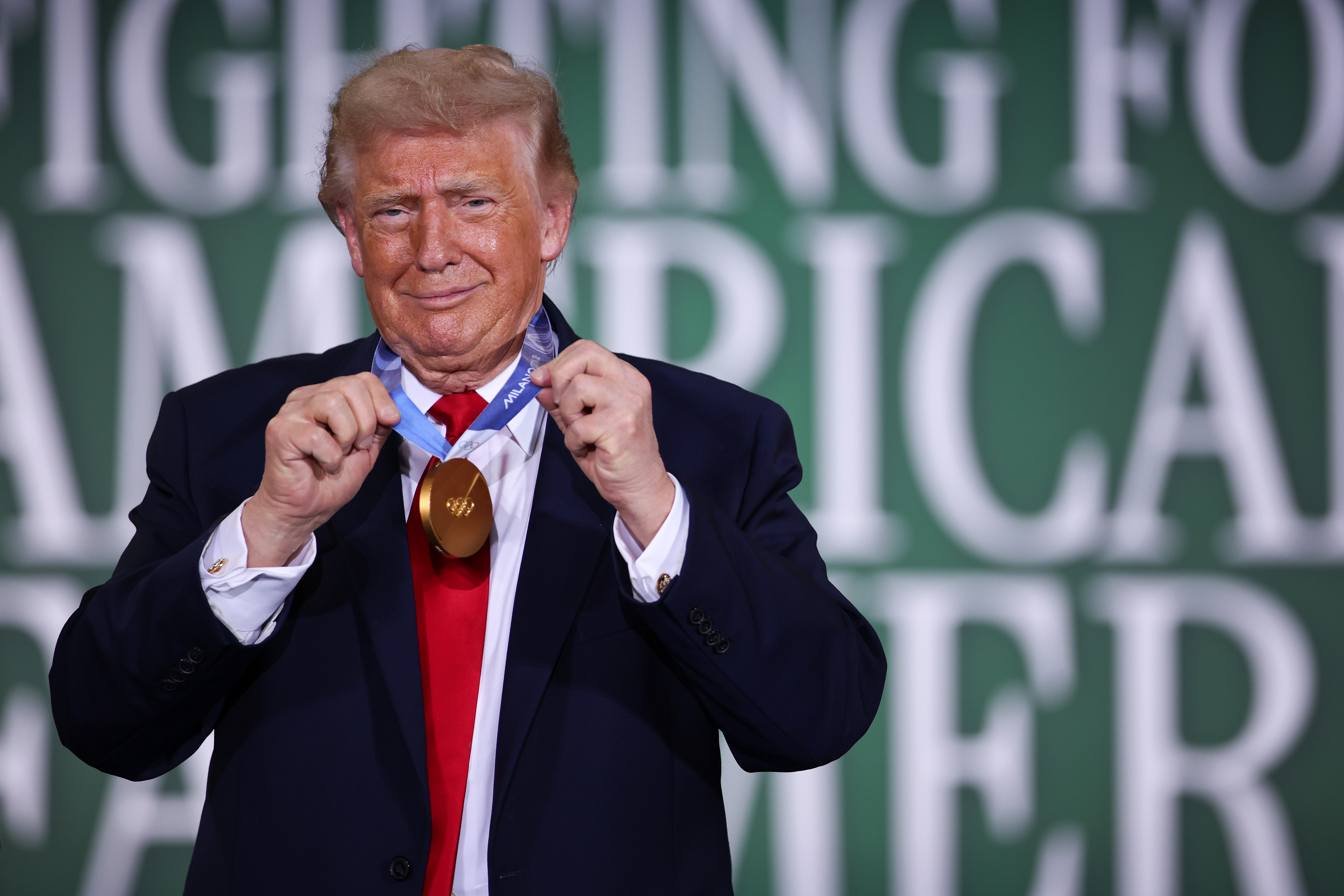 CHIPPEWA FALLS, WISCONSIN - JUNE 05: U.S. President Donald Trump wears the Olympic gold medal of Team USA speedskater Jordan Stolz during a roundtable on agriculture at Custer Farms on June 05, 2026 in Chippewa Falls, Wisconsin. President Trump delivered remarks on his administration's agricultural policies and efforts to support farmers. (Photo by Samuel Corum/Getty Images)