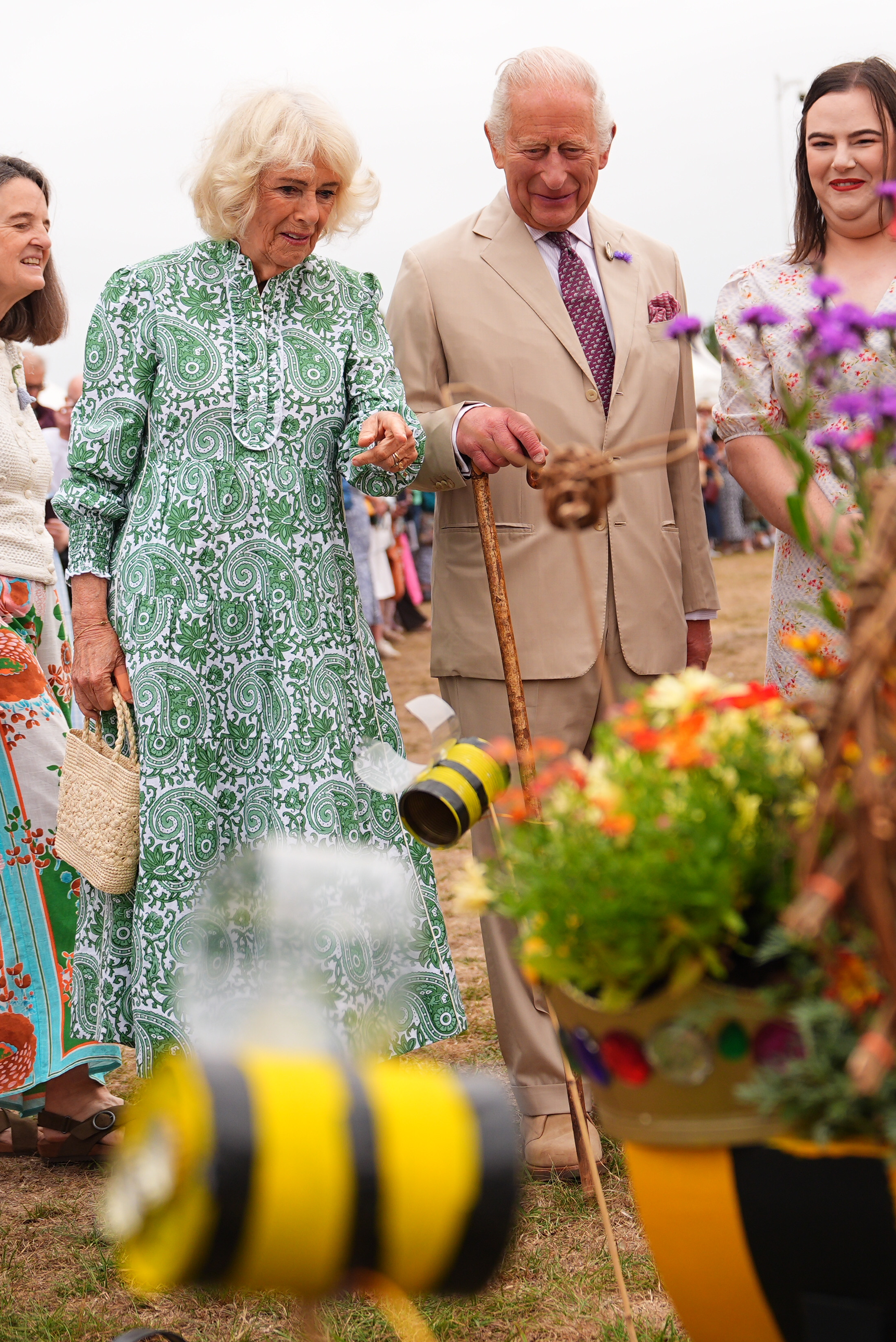 SANDRINGHAM, NORFOLK - JULY 22: King Charles III, Patron of the Royal Horticultural Society (RHS), and Queen Camilla view the Queen Bee garden, designed by Ingoldisthorpe Church of England Primary School, during a visit to the RHS Sandringham Flower Show, which is being held for the first time this year on the Sandringham Estate on July 22, 2026 in Sandringham, Norfolk. The event was the first first Royal Horticultural Society (RHS) show to be held at Sandringham Estate. (Photo by Aaron Chown - WPA Pool/Getty Images)
