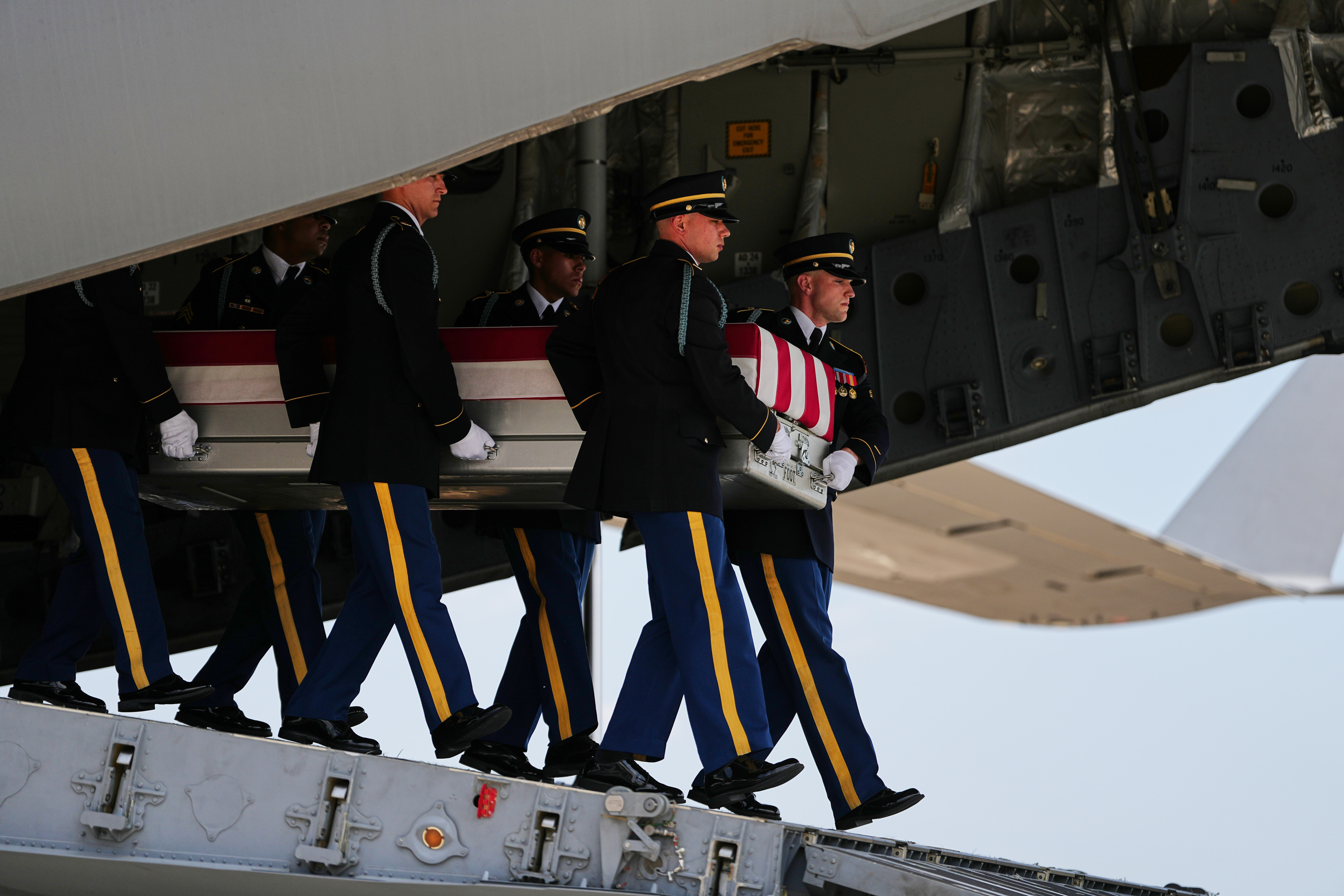 A U.S. Army carry team moves a transfer case containing the remains of 1st Lt. Tyler James Feehan of Ewa Beach, Hawaii, Wednesday, July 22, 2026, at Dover Air Force Base, Del. (AP Photo/Matt Rourke)