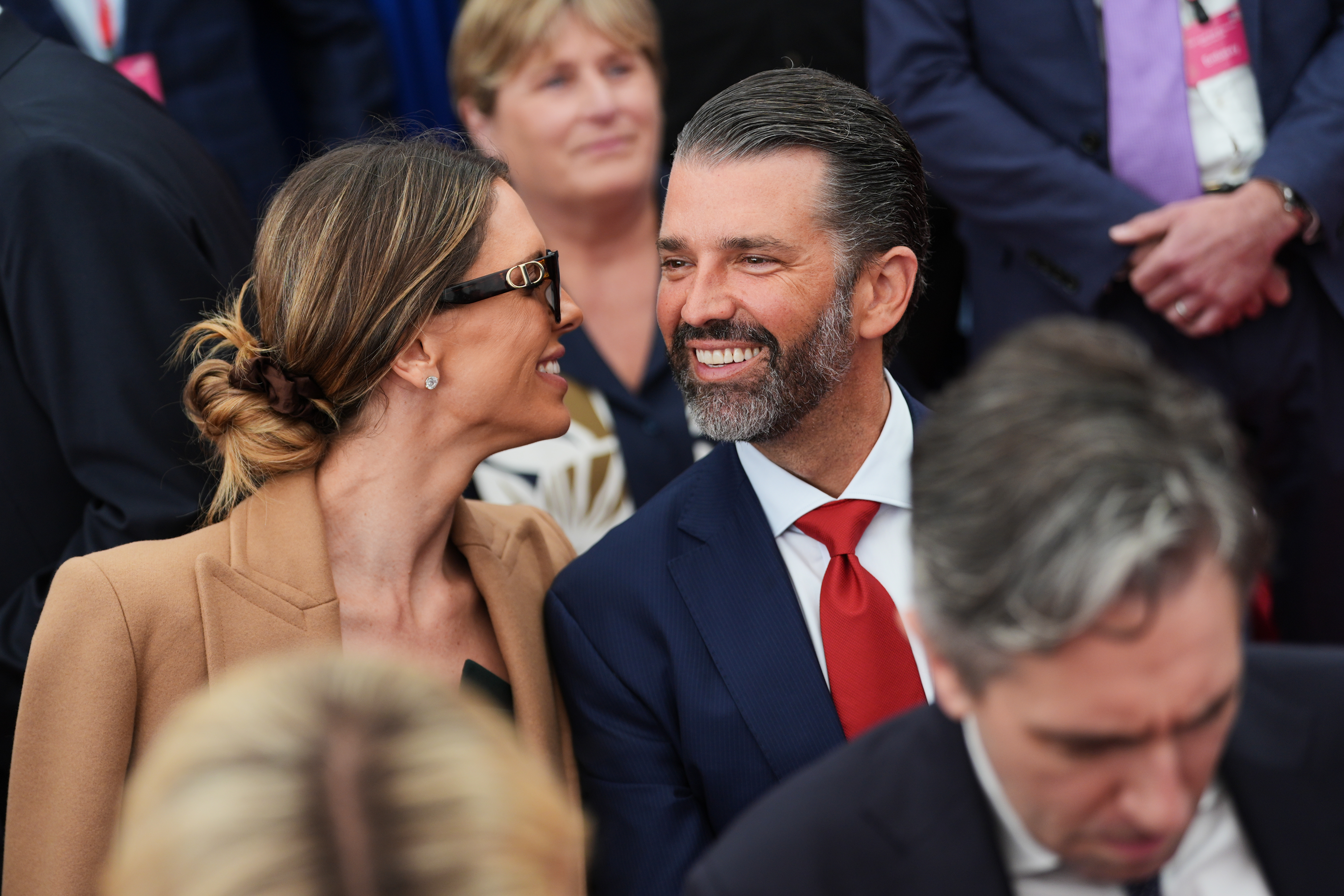 Donald Trump Jr, center, speaks with his wife Bettina, left, as they wait for U.S. President Donald Trump to deliver remarks to U.S. embassy staff at Deerfield Residence in Dublin, Saturday, Sept. 12, 2026. (AP Photo/Julia Demaree Nikhinson)
