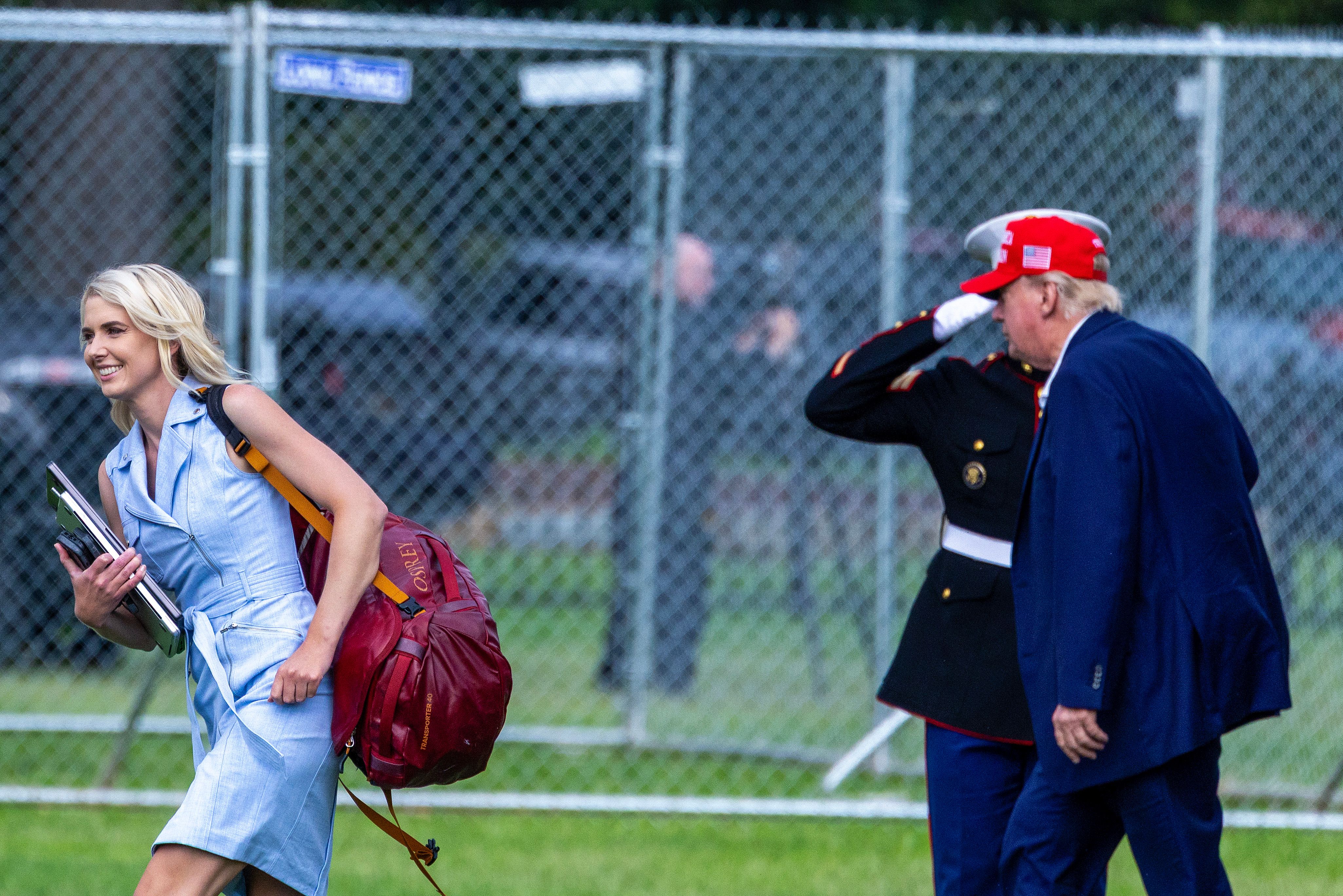 WASHINGTON, DC - AUGUST 16: U.S. President Donald Trump and Natalie Harp, aide to U.S. President Donald Trump walk after landing at the Ellipse near the White House on August 16, 2026 in Washington, DC. President Trump spent the weekend at his Bedminster, New Jersey golf club. (Photo by Tasos Katopodis/Getty Images)