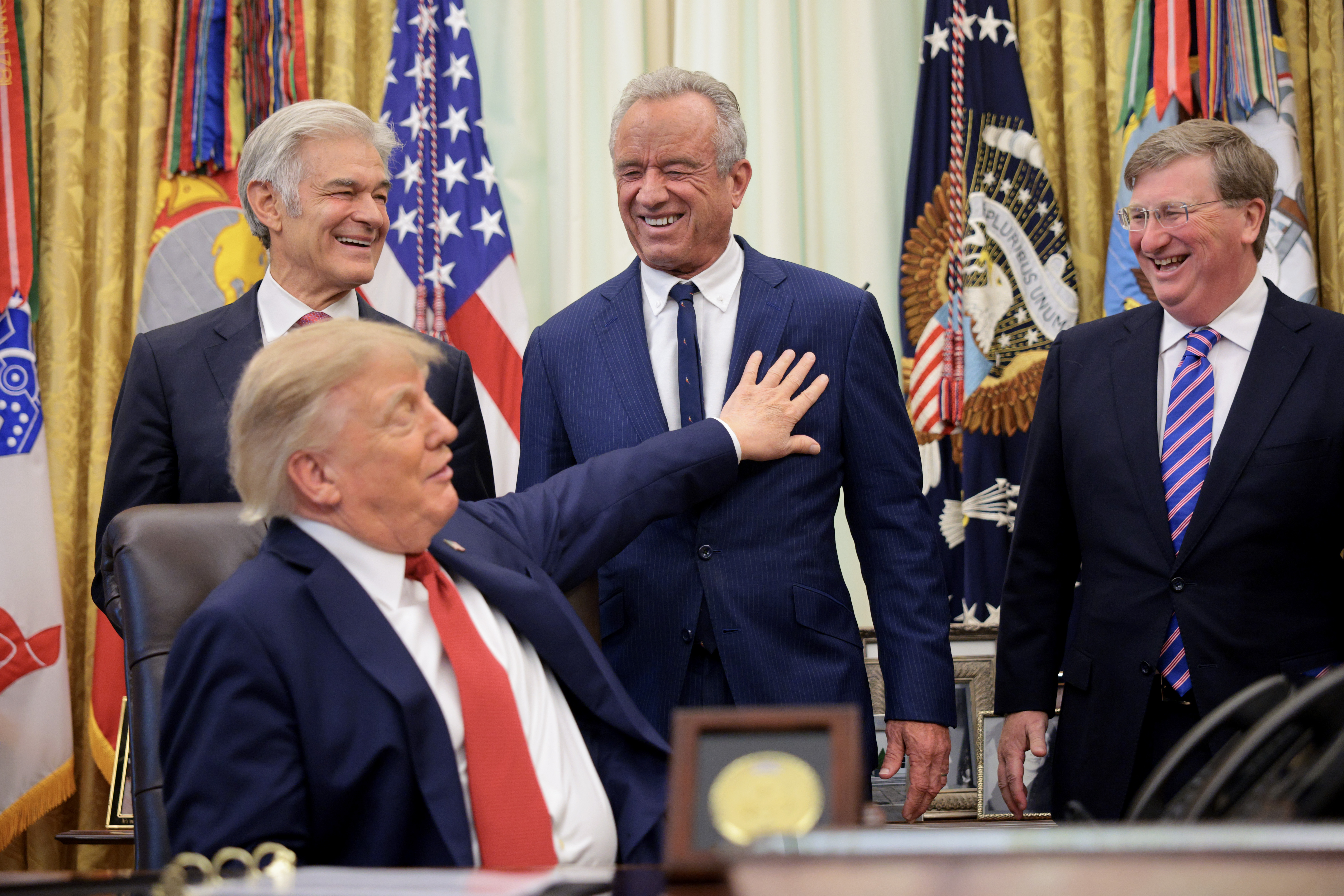 WASHINGTON, DC - SEPTEMBER 18: U.S. President Donald Trump shares a laugh with (L-R) Administrator for the Centers for Medicare & Medicaid Services Dr. Mehmet Oz, U.S. Secretary of Health and Human Services Robert F. Kennedy Jr. and Mississippi Gov. Tate Reeves as Trump addresses healthcare in the Oval Office at the White House on September 18, 2026 in Washington, DC. Trump announced that his administration's Medicaid ​