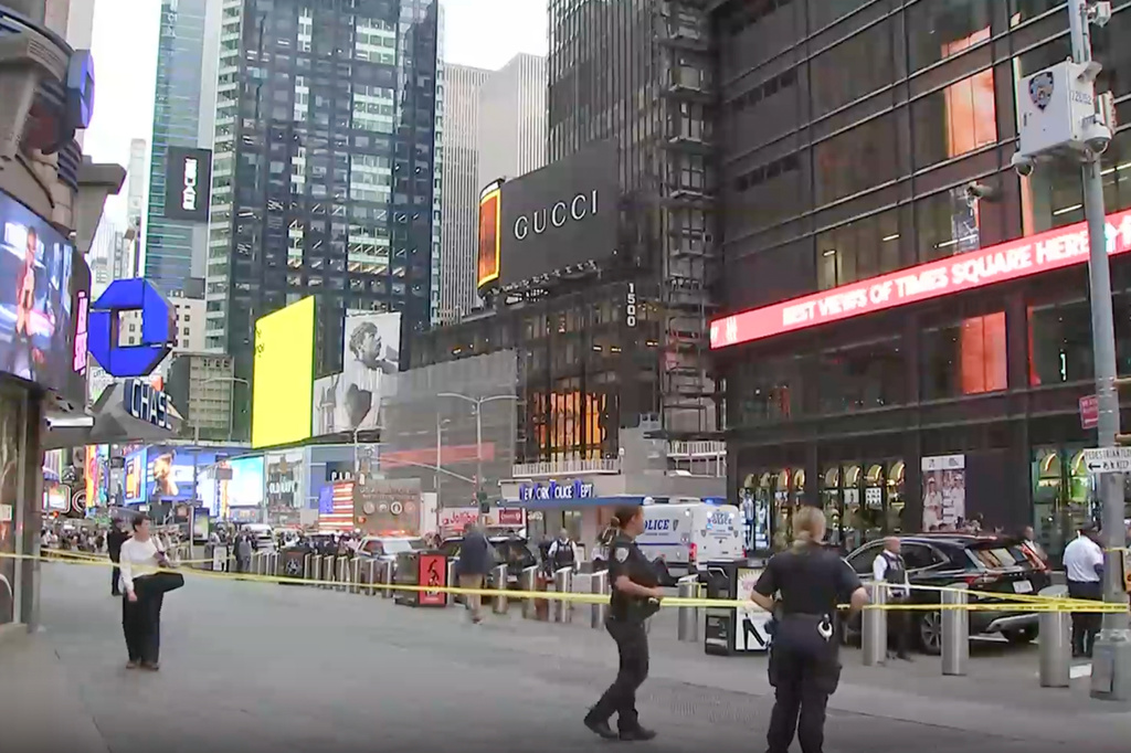This image made from video provided by WABC-TV shows NYPD officers on the scene after a woman brandishing two large knives was shot by officers in Times Square in New York, Monday, Aug. 31, 2026. (WABC via AP)