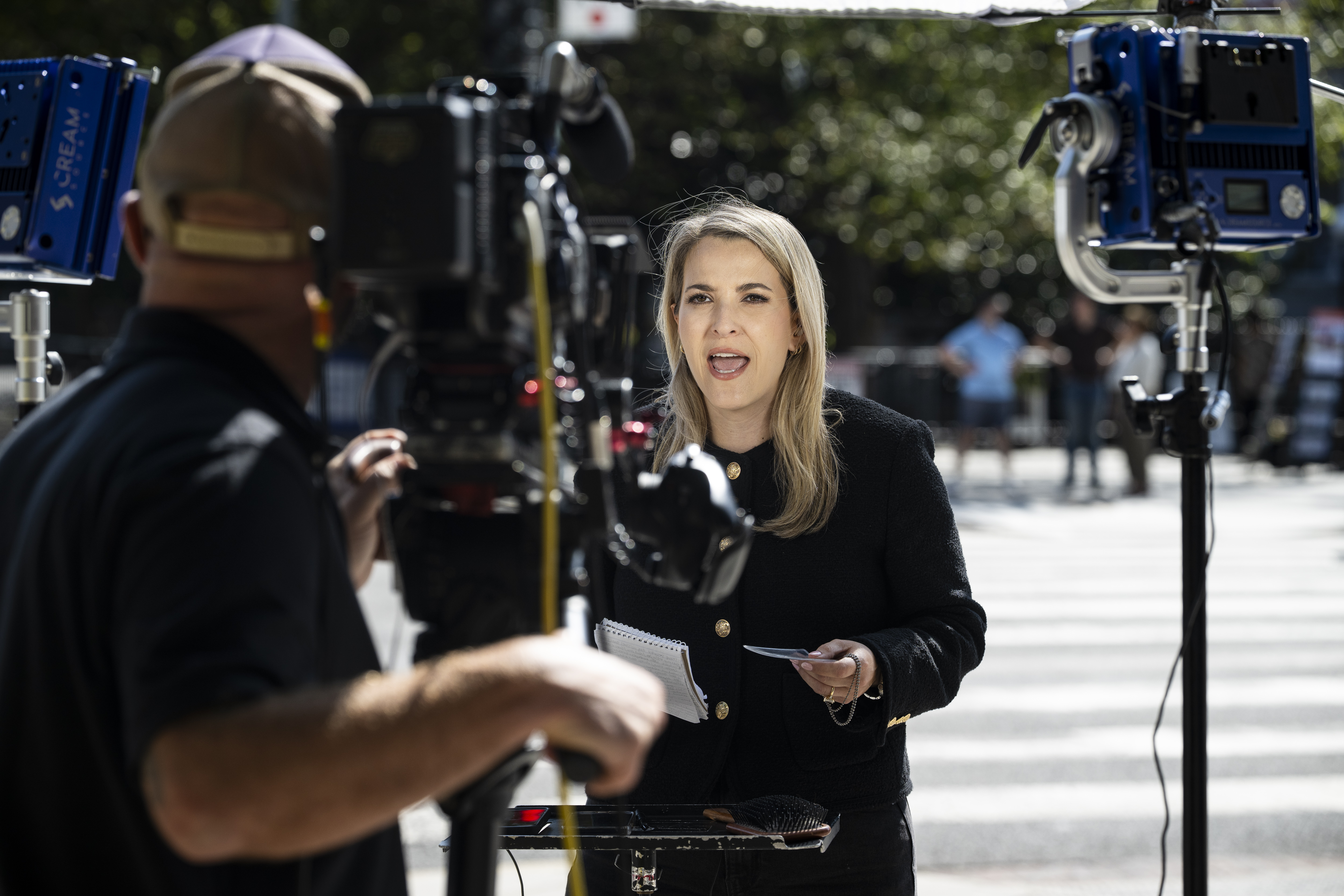 WASHINGTON, DC - SEPTEMBER 19: CNN Senior White House Report Betsy Klein holds an empty credential lanyard during a television report on a street corner outside the White House grounds after earlier being denied entry, on September 19, 2026 in Washington, DC. (Photo by Graeme Sloan/Getty Images)