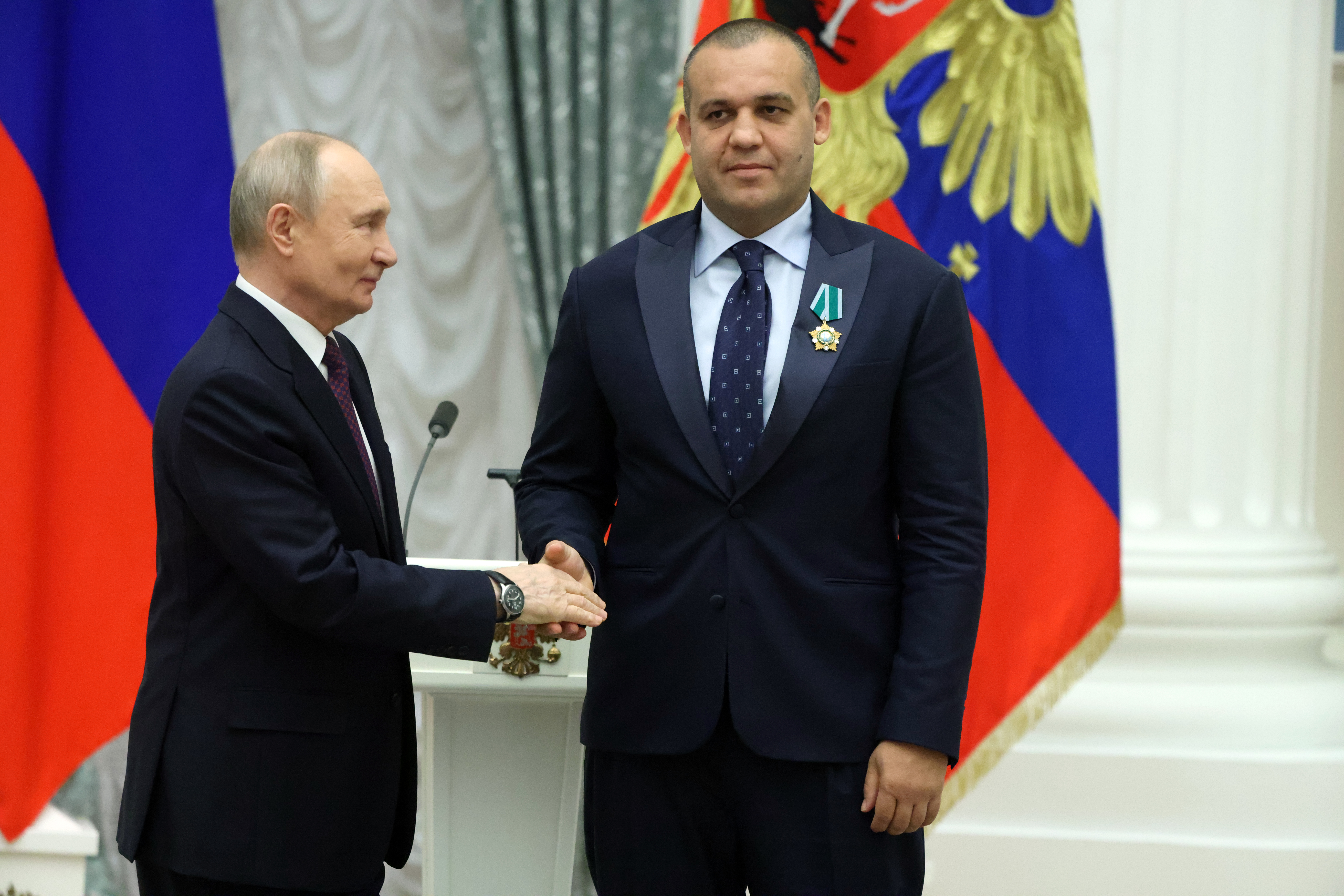 MOSCOW, RUSSIA - APRIL 22: Russia's President Vladimir Putin (L) greets sport fonctionare and businessman Umar Kremlev (Kremlyov) (R) during his meeting with national boxing team at Kremlin on April 22, 2026 in Moscow, Russia. Putin received and awarded Russian athlets who won the World Boxing Championships. (Photo by Contributor/Getty Images)