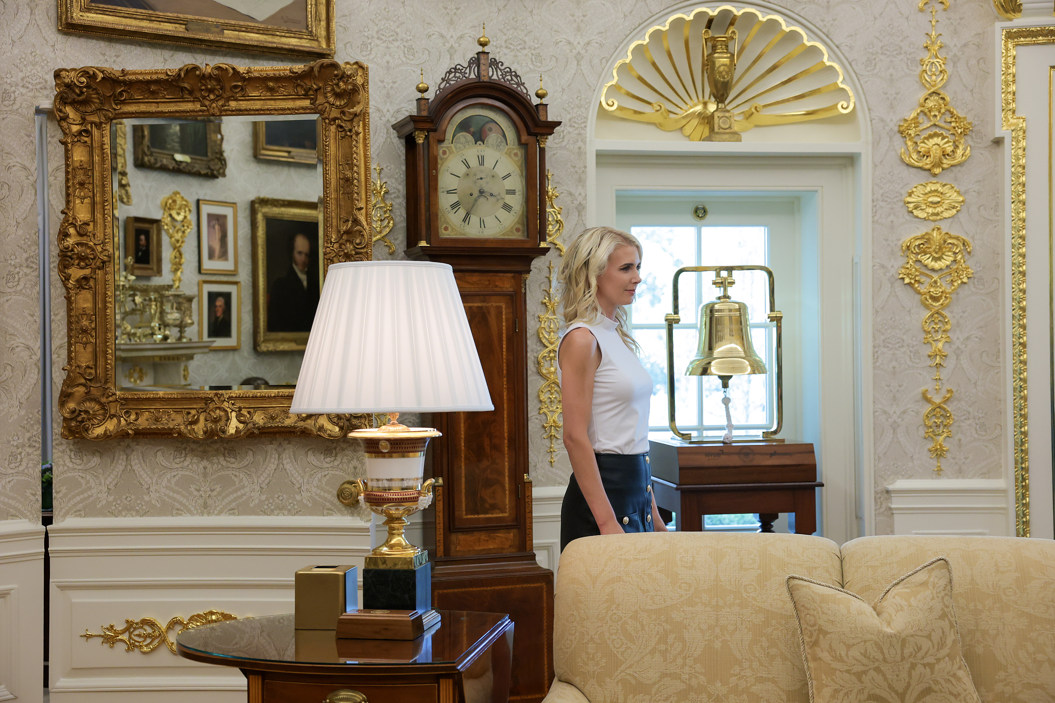 WASHINGTON, DC - AUGUST 10: Executive Assistant to the President Natalie Harp stands in the Oval Office as U.S. President Donald Trump signs an executive order calling for childhood vaccine shots to be spaced out into separate visits at the White House on August 10, 2026 in Washington, DC. During his second term, Trump has urged Health and Human Services Secretary Robert F. Kennedy Jr. to investigate further research on vaccines. (Photo by Anna Moneymaker/Getty Images)