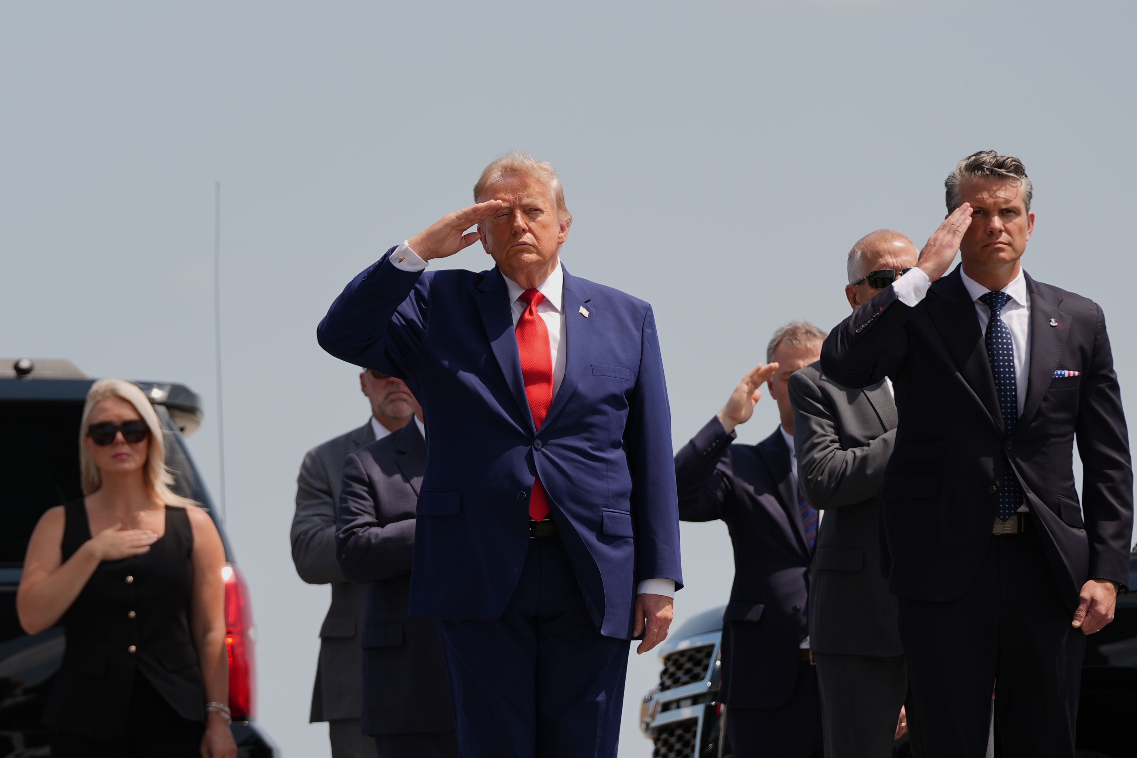 President Donald Trump, left, and Defense Secretary Pete Hegseth, right, salute as a U.S. Army carry team moves a transfer case containing the remains of 1st Lt. Tyler James Feehan of Ewa Beach, Hawaii, Wednesday, July 22, 2026, at Dover Air Force Base, Del. (AP Photo/Julia Demaree Nikhinson)