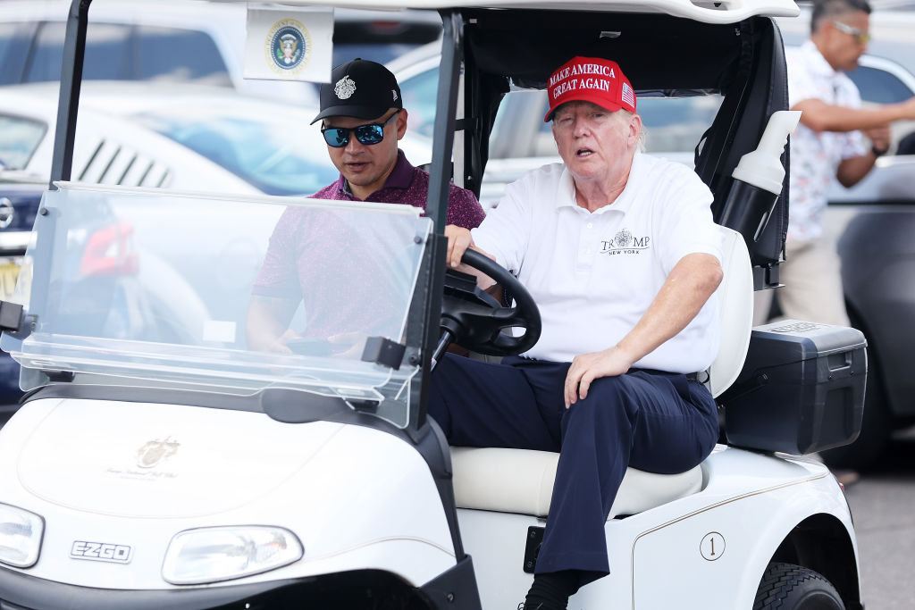 BEDMINSTER, NEW JERSEY - AUGUST 13: Former President Donald Trump drives a golf cart accompanied by aide Walt Nauta prior to the start of day three of the LIV Golf Invitational - Bedminster at Trump National Golf Club on August 13, 2023 in Bedminster, New Jersey. (Photo by Mike Stobe/Getty Images)