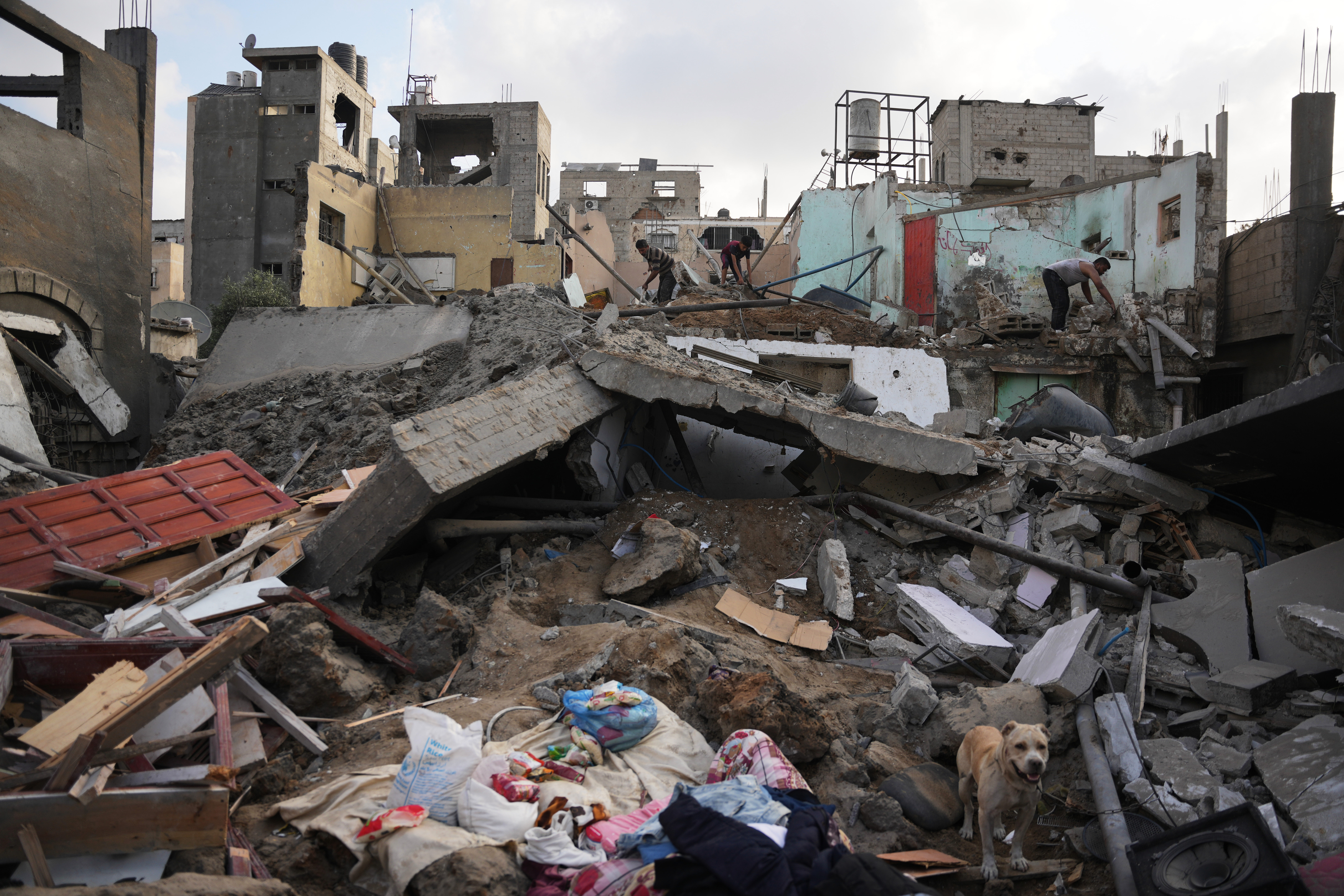 Palestinians inspect destroyed buildings at the site of an Israeli airstrike, at al-Maghazi refugee camp, central Gaza Strip, Friday, July 24, 2026. (AP Photo/Abdel Kareem Hana)