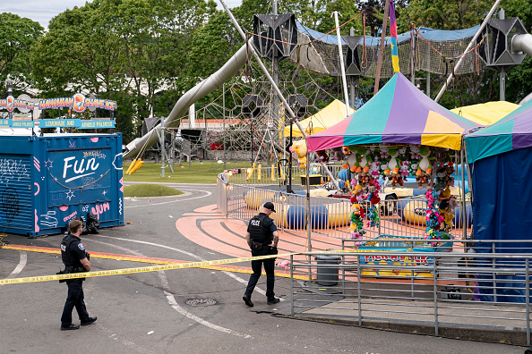 SEATTLE, WASHINGTON - JULY 26: Police officers walk on patrol at the scene of a mass shooting at the Bite of Seattle food festival on July 26, 2026 in Seattle, Washington. At least two people are dead and at least five are wounded after a mass shooting at the event at Seattle Center. (Photo by David Ryder/Getty Images)