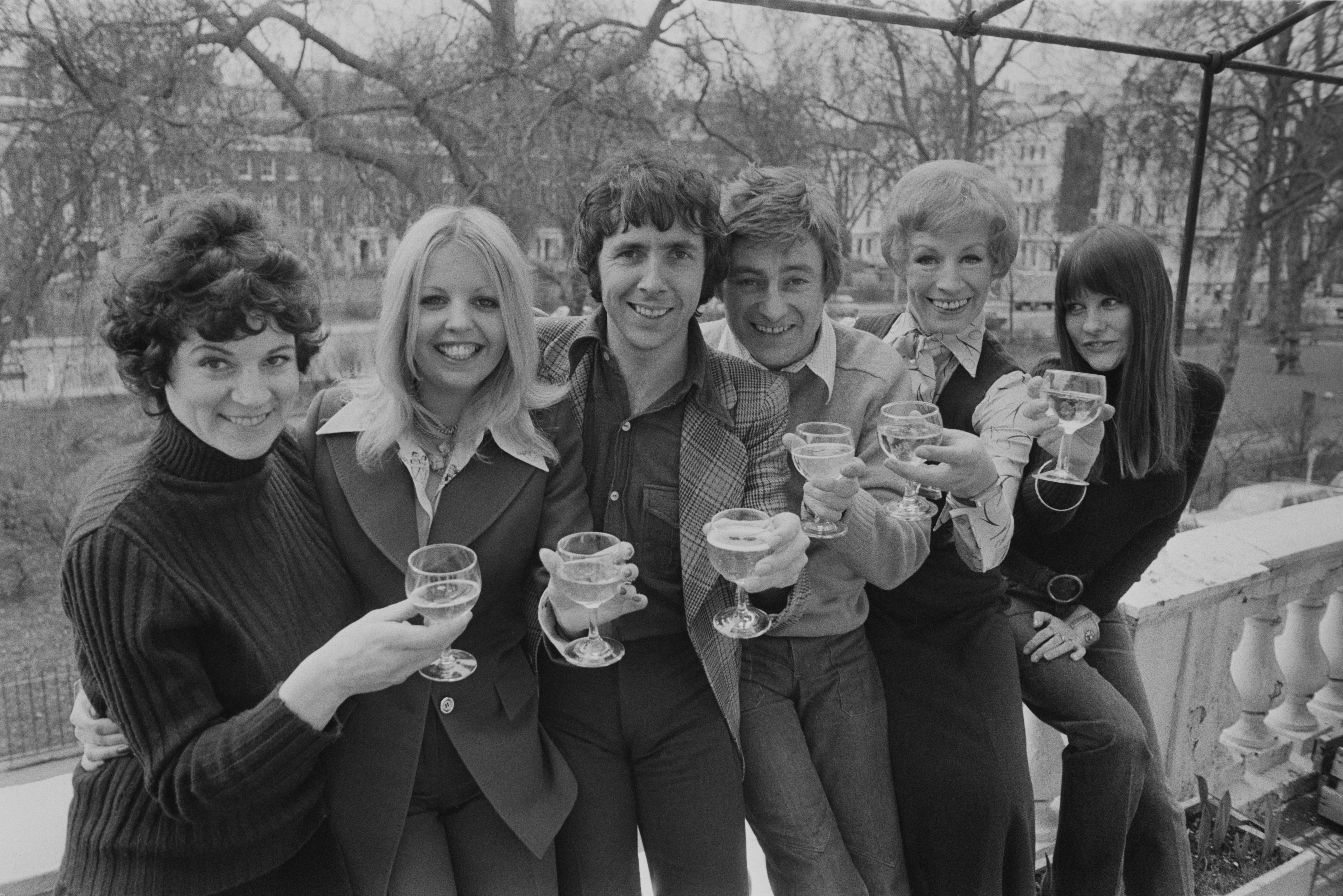 A photocall for the stage play 'Boeing-Boeing', featuring several cast members of the British sitcom 'Man About The House', at the Irish Club in Easton Square, London, 18th February 1975. From left to right, Penelope Nice, Sally Thomsett, Richard O'Sullivan, Doug Fisher, Yootha Joyce and Judy Matheson. The production will begin a national tour shortly. (Photo by Frank Barrett/Keystone/Hulton Archive/Getty Images)