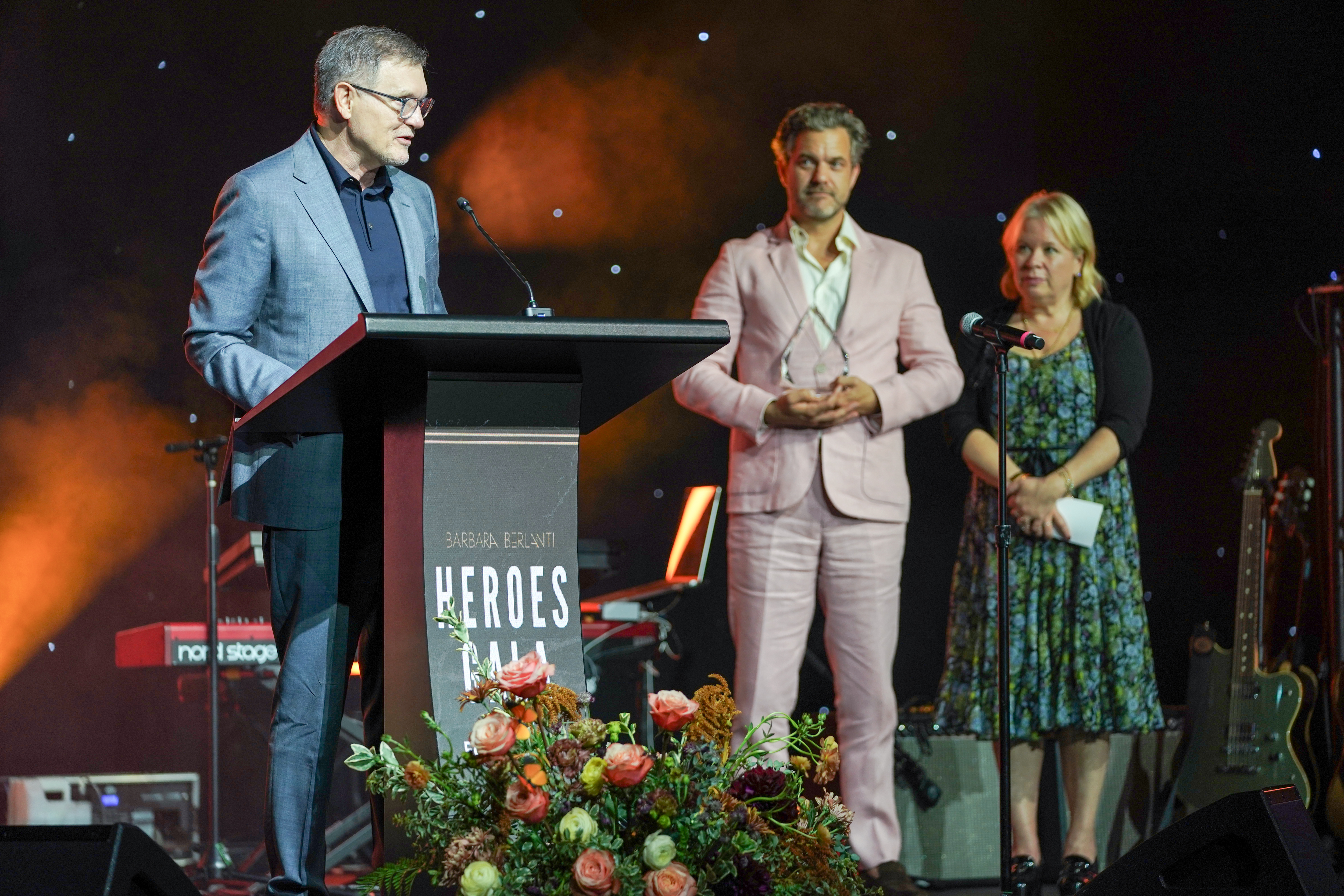 SANTA MONICA, CALIFORNIA - OCTOBER 03: (L-R) Barbara Berlanti Hero Award winner Kevin Williamson, Joshua Jackson and Julie Plec speak onstage during the Barbara Berlanti Heroes Gala Benefiting F Cancer at Barker Hangar on October 03, 2026 in Santa Monica, California. (Photo by Chris Frawley/Getty Images)