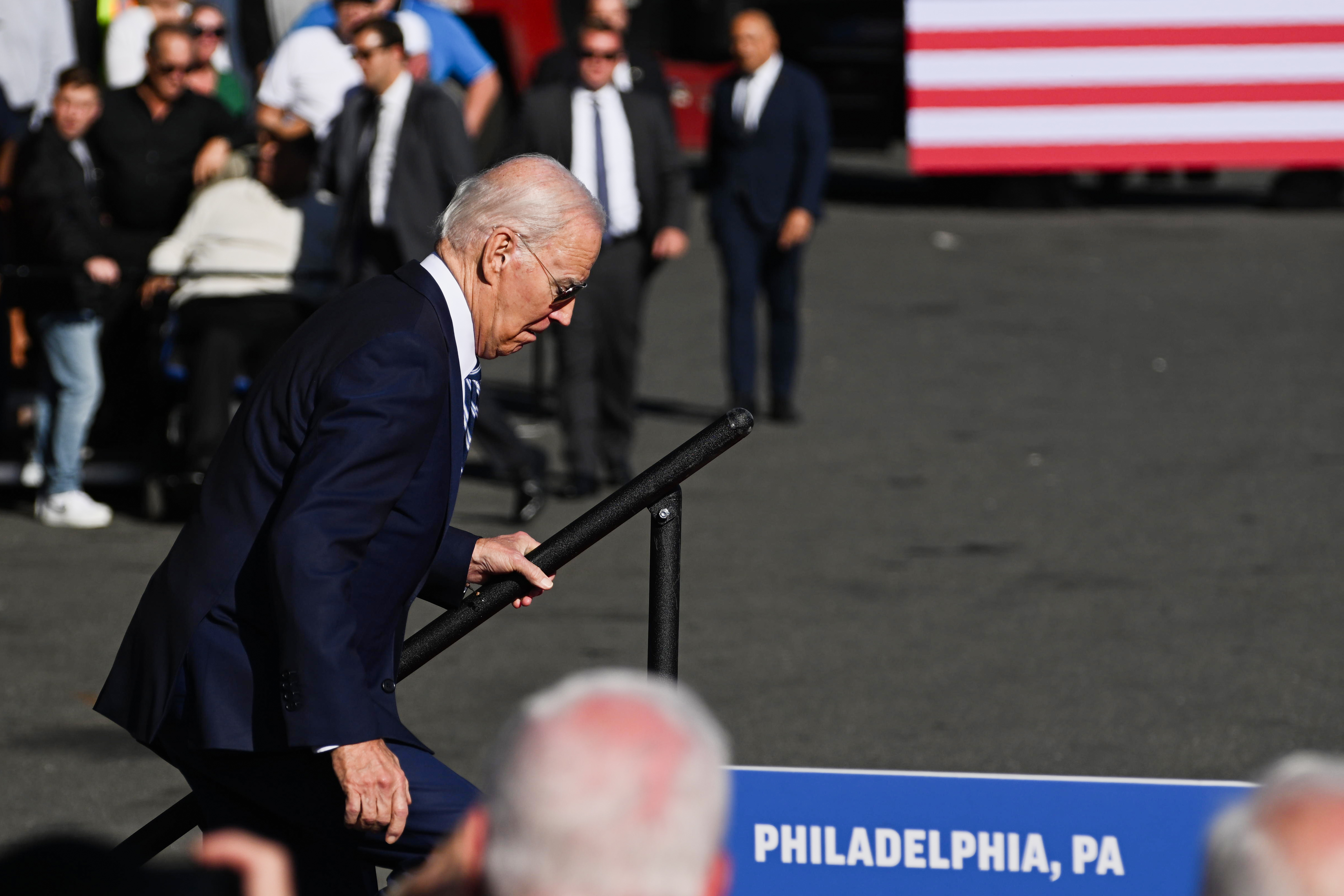 PHILADELPHIA, PENNSYLVANIA - OCTOBER 13:  President Joe Biden reacts as he stumbles while taking the stage to speak at Tioga Marine Terminal on October 13, 2023 in Philadelphia, Pennsylvania. Biden discussed how his Bidenomics agenda is creating good-paying union jobs, investing in infrastructure, accelerating the transition to a clean energy future, and combatting the climate crisis.(Photo by Mark Makela/Getty Images)