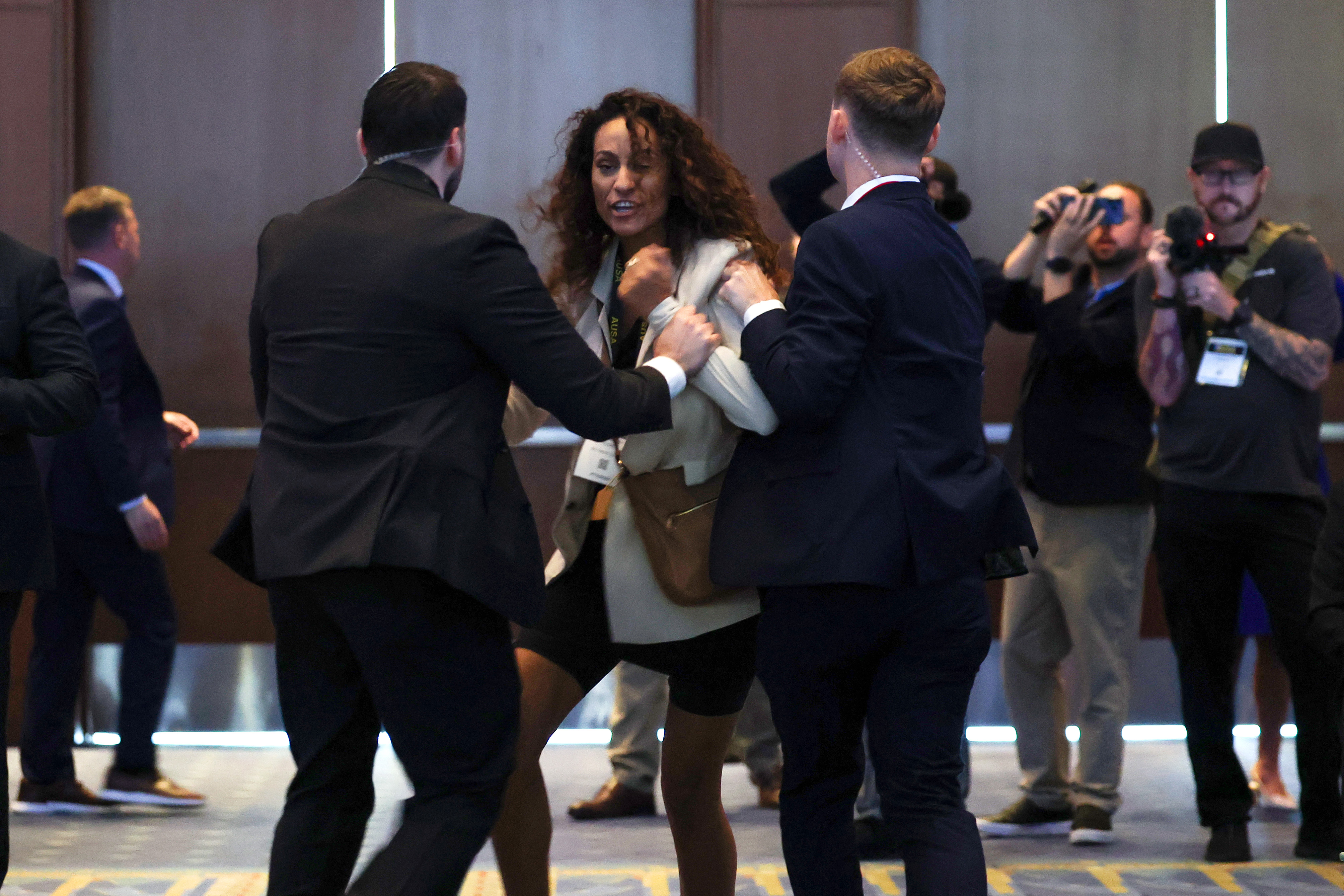 WASHINGTON, DC - OCTOBER 14: A protestor is removed after interrupting a discussion with U.S. Secretary of War Pete Hegseth during the U.S. Army's 2026 Annual Meeting and Exposition at the Walter E. Washington Convention Center on October 14, 2026 in Washington, DC. Secretary Hegseth participated in a discussion on the future of autonomous warfare. (Photo by Kevin Dietsch/Getty Images)