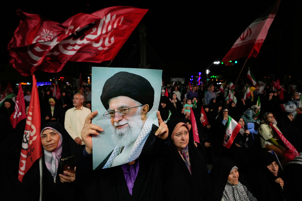 A pro-government demonstrator holds up a poster of the late Iranian Supreme Leader Ayatollah Ali Khamenei, who was killed in the U.S. and Israel strike on Feb. 28, during a gathering in a square in Tehran, Iran, Wednesday, Aug. 26, 2026. (AP Photo/Vahid Salemi)