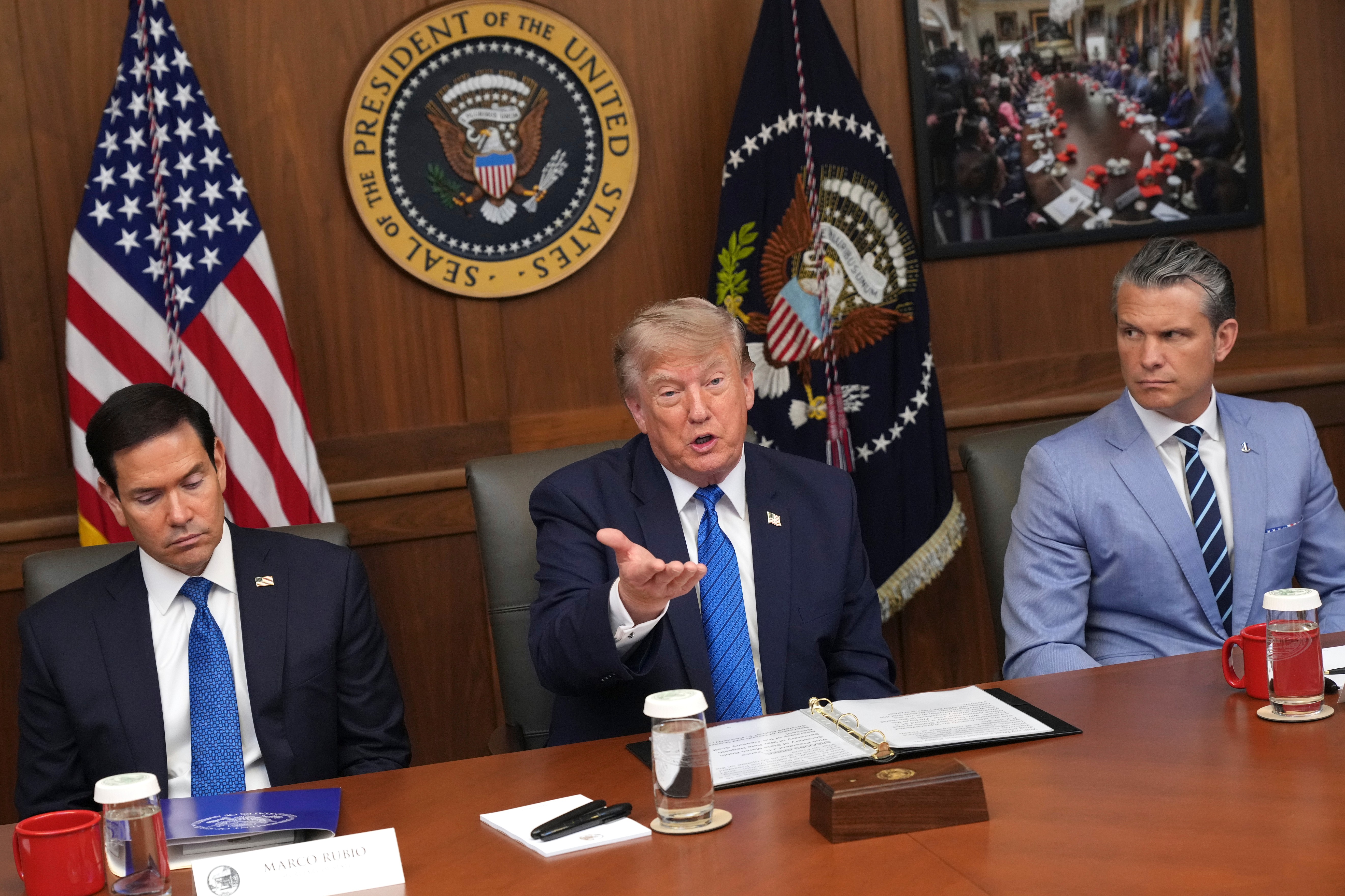 President Donald Trump speaks as Secretary of State Marco Rubio, left, and Defense Secretary Pete Hegseth listen during a cabinet meeting, Friday, July 31, 2026, at Camp David, the presidential retreat, near Thurmont, Md., Friday, July 31, 2026. (AP Photo/Jacquelyn Martin)