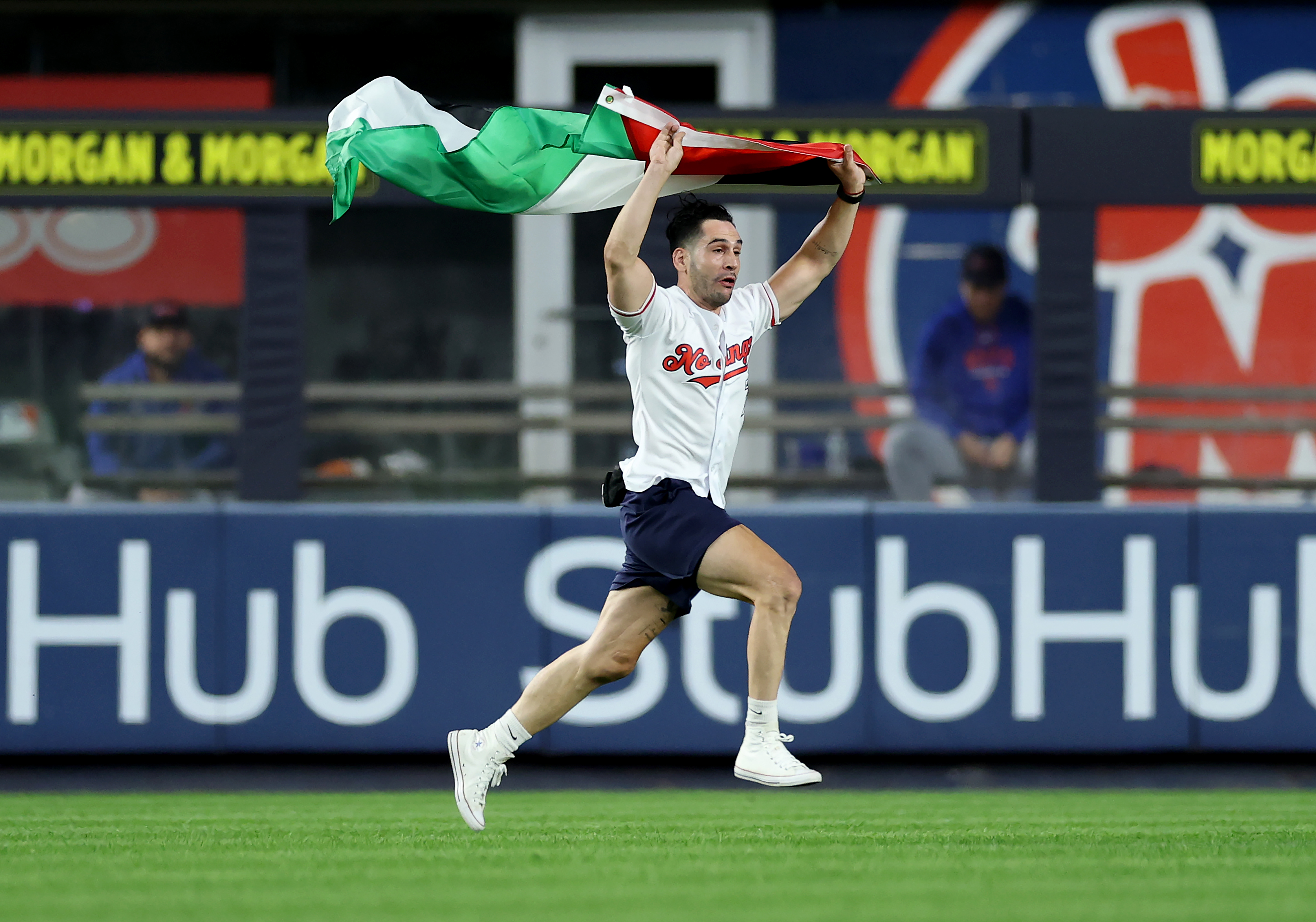 NEW YORK, NEW YORK - SEPTEMBER 11:   A fan carrying a Palestinian flag runs onto the field at 9:11PM in the middle of the seventh inning at Yankee Stadium on September 11, 2026 in The Bronx borough of New York City. The New York Yankees and the New York Mets are wearing hats and using gear to honor the memory of the first responders on the 25th anniversary of the 9/11 attacks. (Photo by Elsa/Getty Images)