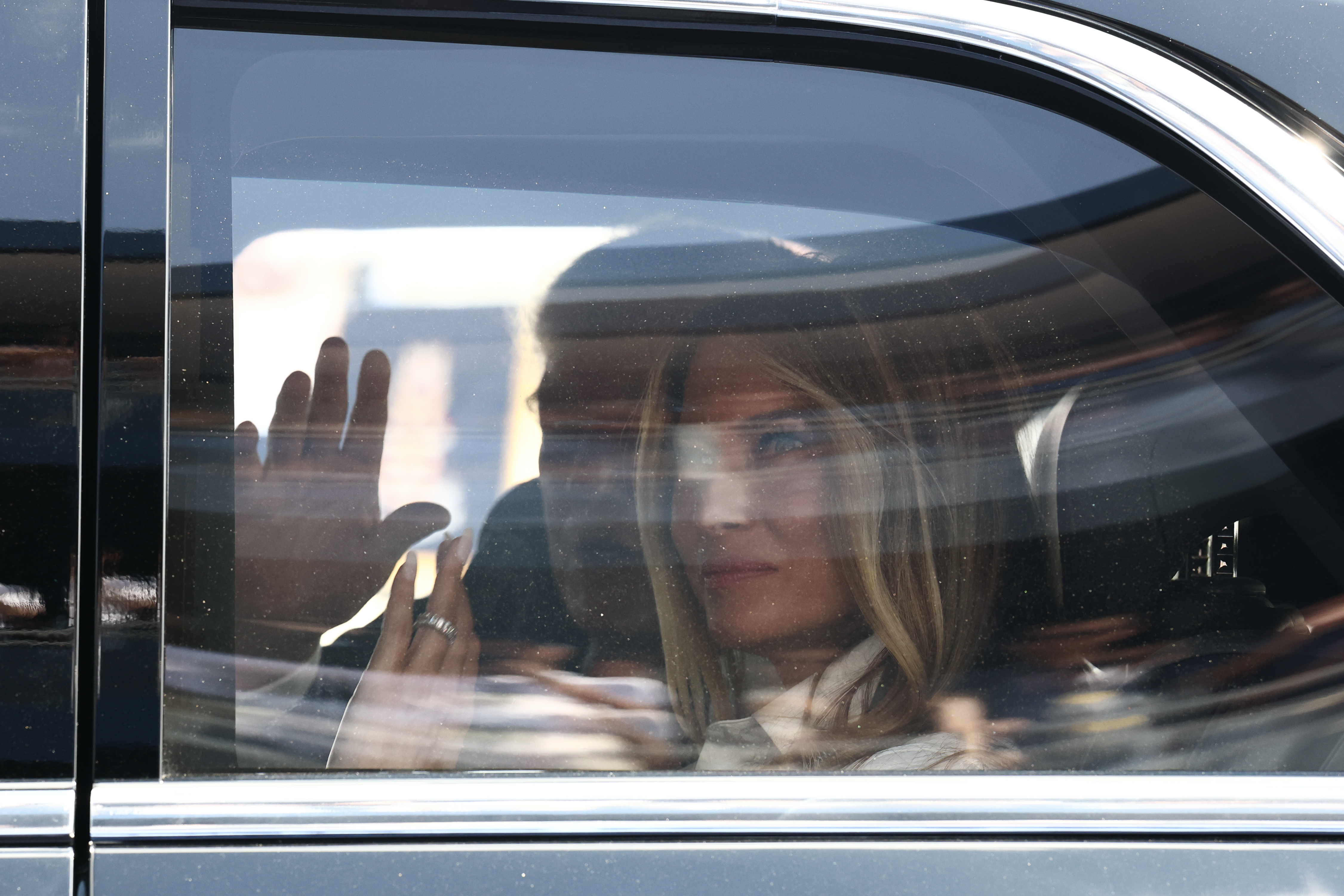 WASHINGTON, DC - AUGUST 23: U.S. President Donald Trump and first lady Melania Trump wave to fans from the track at the NTT INDYCAR Series on August 23, 2026 in Washington, DC. U.S. President Donald Trump established the Freedom 250 Grand Prix weekend as part of the yearlong celebration of America's 250th anniversary.  (Photo by Finn Gomez/Getty Images)