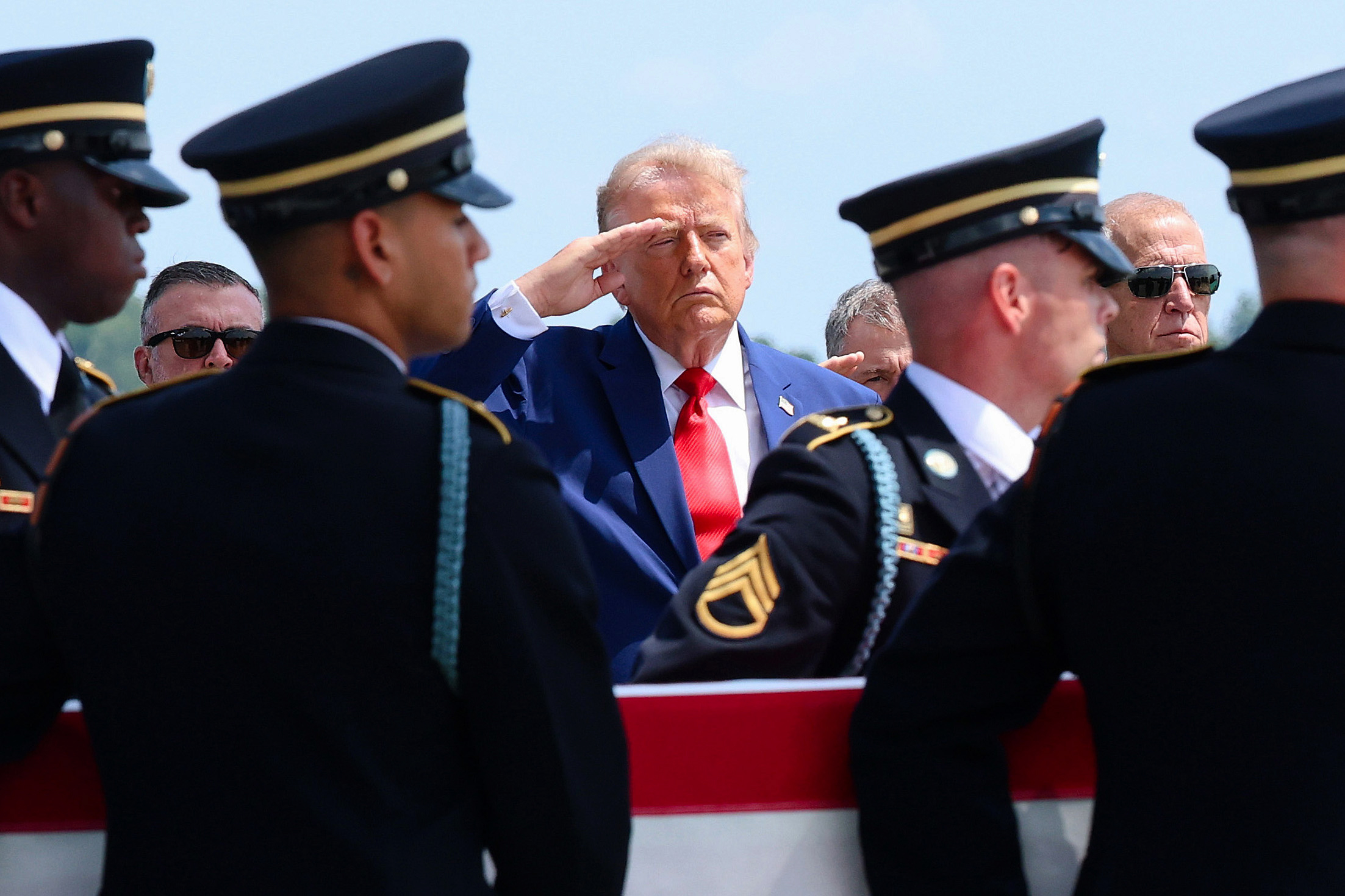 DOVER, DELAWARE - JULY 22: U.S. President Donald Trump (C) salutes as members of a U.S. Army carry team move the flag-draped transfer case holding the remains of Army Pvt. Isabella Gonzales, of Carrollton, Texas, during a dignified transfer at Dover Air Force Base July 22, 2026 in Dover, Delaware. Pvt. Gonzales, who was assigned to 1st Battalion, 57th Air Defense Artillery Regiment, 52nd Air Defense Artillery Brigade, 10th Army Air Missile Defense Command in Ansbach, Germany, was killed in action during an enemy attack on July 17, 2026, at Muwaffaq Salti Air Base in Jordan. (Photo by Kevin Dietsch/Getty Images)