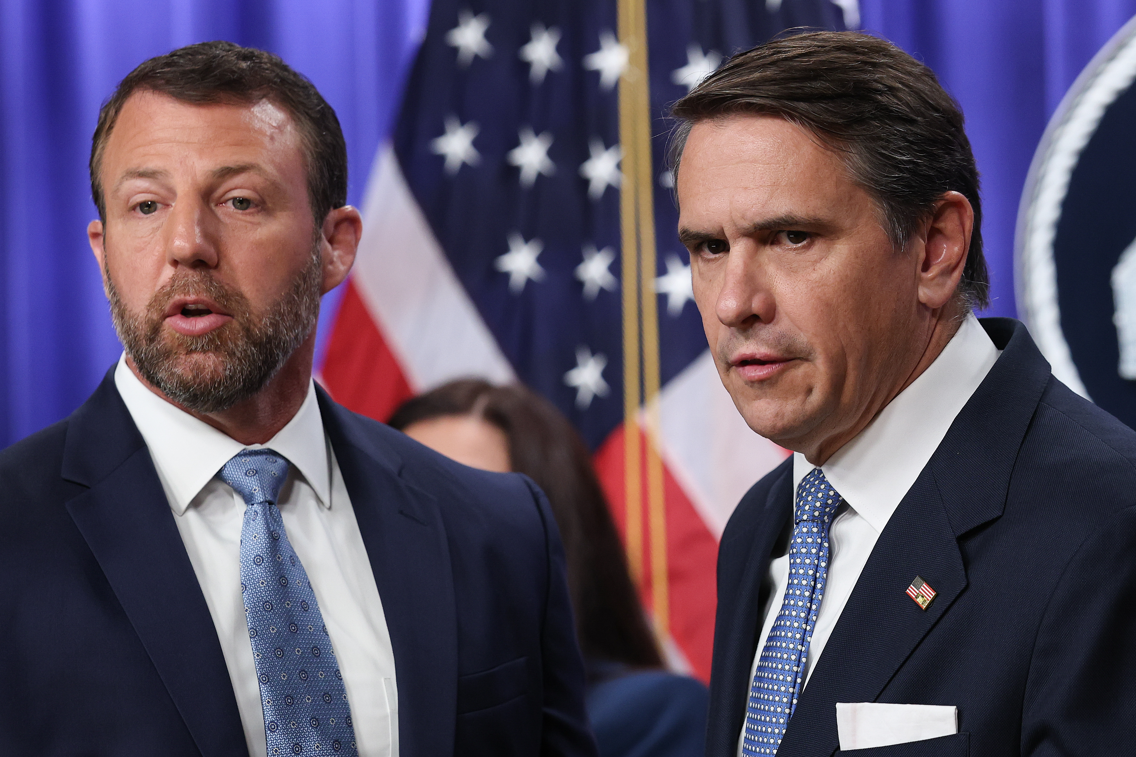 WASHINGTON, DC - JUNE 11: Acting U.S. Attorney General Todd Blanche listens to a reporter's question during a press conference with U.S. Secretary of Homeland Security Markwayne Mullin (L) at the Department of Justice June 11, 2026 in Washingon, DC. The press conference centered on government efforts to locate and secure unaccompanied immigrant children.  (Photo by Win McNamee/Getty Images)
