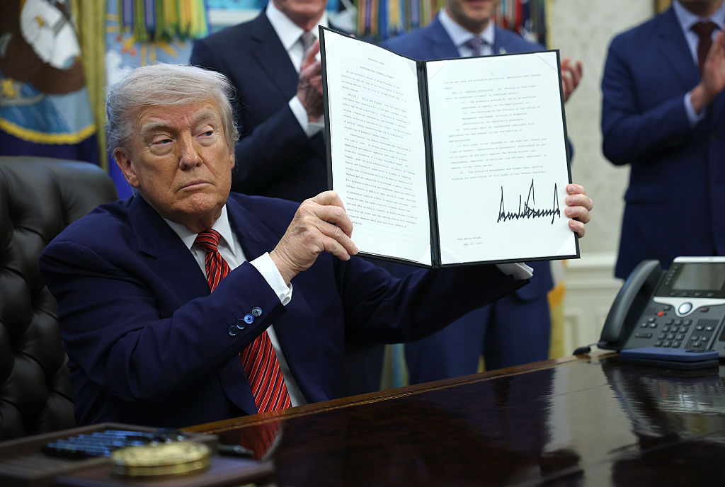 WASHINGTON, DC - MAY 23: U.S. President Donald Trump holds up a signed executive order in the Oval Office of the White House May 23, 2025 in Washington, DC. President Trump signed executive orders related to the nuclear power industry.  (Photo by Win McNamee/Getty Images)