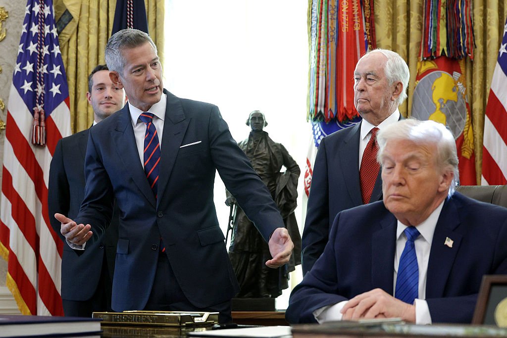WASHINGTON, DC - JANUARY 30: U.S. Secretary of Transportation Sean Duffy speaks alongside Roger Penske, Chair of the Penske Corporation, and U.S. President Donald Trump, as  Trump signs an executive order in the Oval Office of the White House on January 30, 2026 in Washington, DC. Trump signed an order aimed at bringing an IndyCar race to the District of Columbia this summer as part of the celebration of America’s 250th birthday. (Photo by Alex Wong/Getty Images)
