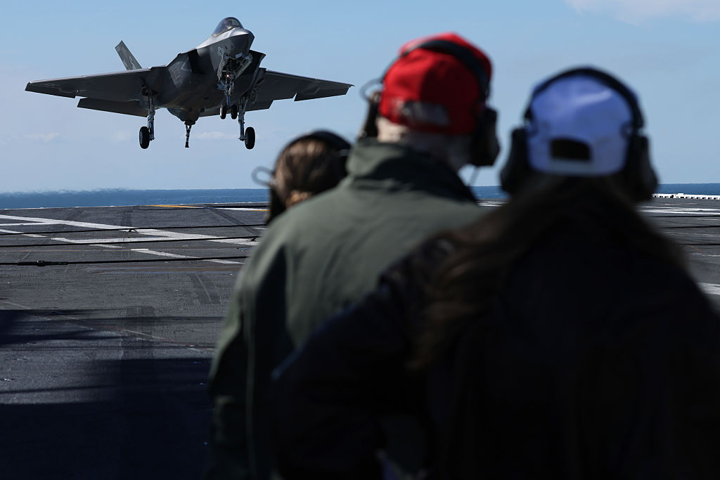 AT SEA - OCTOBER 05: U.S. President Donald Trump and First Lady Melania Trump observe naval flight demonstrations on the deck of the USS George H.W. Bush aircraft carrier on October 5, 2025 off the eastern coast of the United States. President Trump is visiting Naval Station Norfolk in Virginia for a celebration of the 250th birthday of the U.S. Navy.  (Photo by Alex Wong/Getty Images)