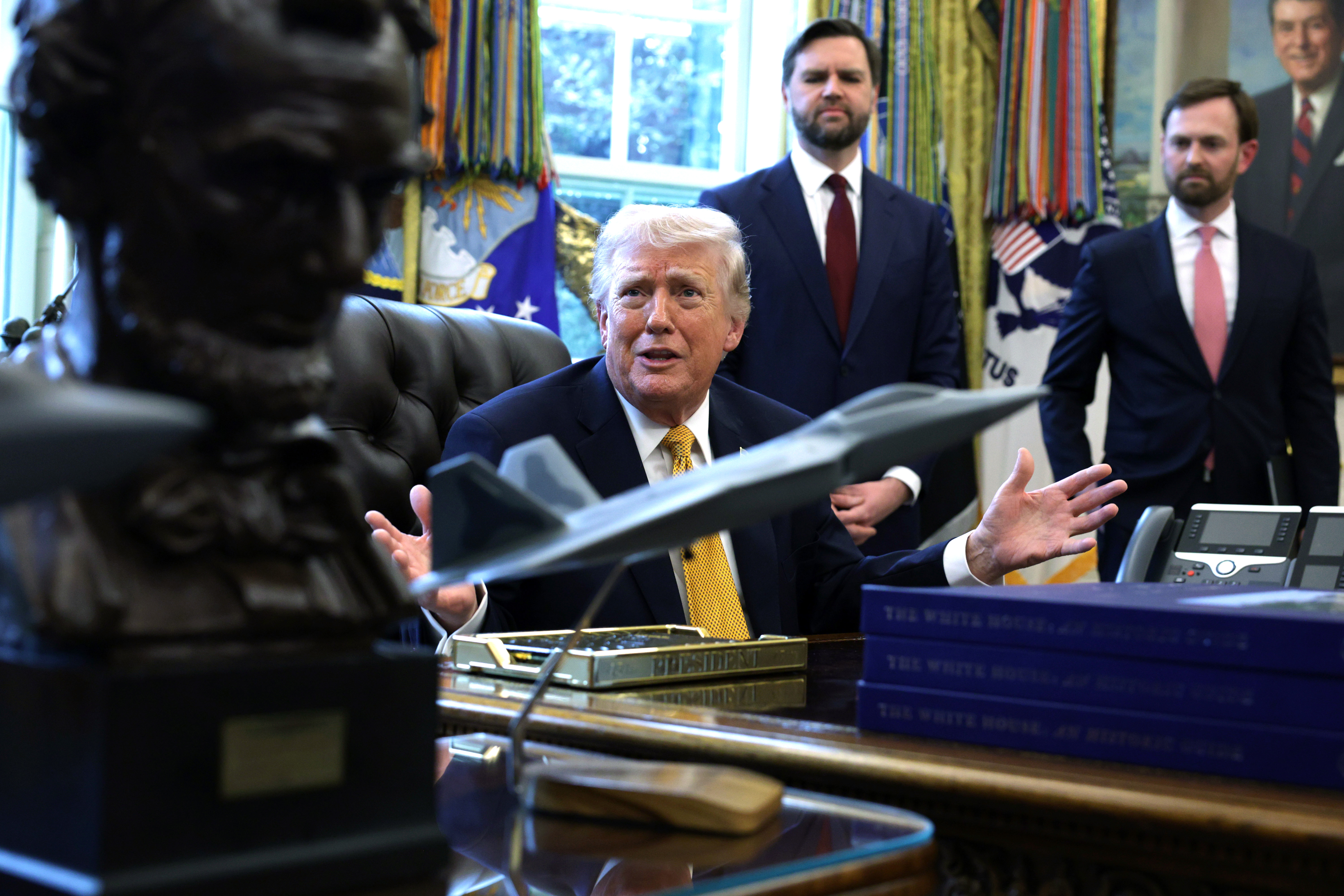 WASHINGTON, DC - MARCH 16: U.S. President Donald Trump speaks to the media after signing a document as Vice President JD Vance (2nd L) and Federal Trade Commission Chairman Andrew Ferguson (R) look on during a White House signing ceremony in the Oval Office of the White House on March 16, 2026 in Washington, DC. Trump signed an executive order to create a task force on fraud which will be lead by Vice President J.D. Vance. (Photo by Alex Wong/Getty Images)