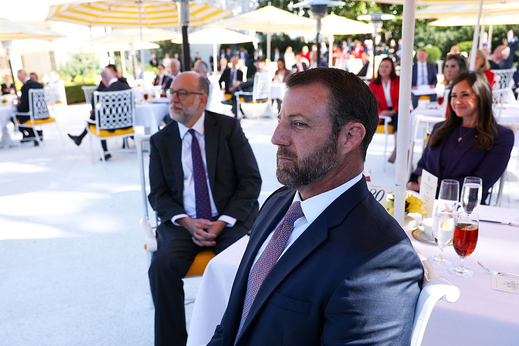 WASHINGTON, DC - OCTOBER 21: U.S. Sen. Markwayne Mullin (R-OK) listens as U.S. President Donald Trump delivers remarks during a luncheon in the Rose Garden of the White House on October 21, 2025 in Washington, DC. President Trump hosted the