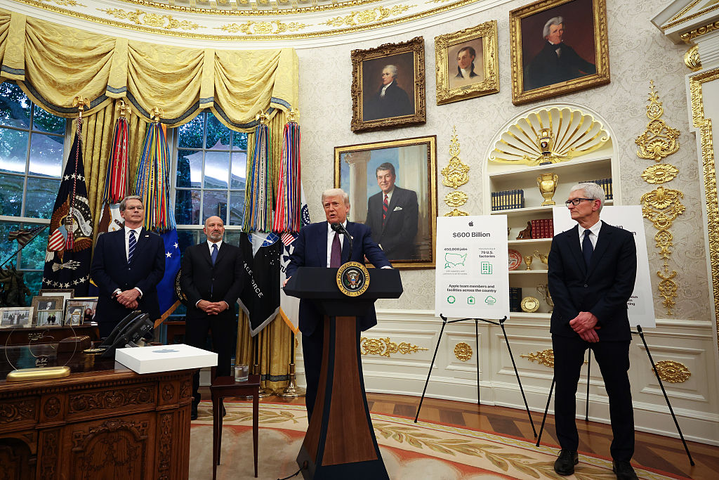 WASHINGTON, DC - AUGUST 06: U.S. President Donald Trump (C) speaks as (L-R) U.S. Treasury Secretary Scott Bessent, U.S. Secretary of Commerce Howard Lutnick and Apple CEO Tim Cook look on during an event in the Oval Office of the White House on August 6, 2025 in Washington, DC. Apple Inc. announced a $100 billion investment in manufacturing facilities in the U.S., on top of an announcement in February committing over the next four years to a $500 billion investment in the U.S. economy and the addition of 20,000 new jobs. (Photo by Win McNamee/Getty Images)