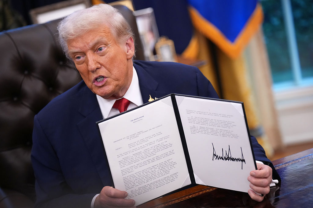 WASHINGTON, DC - SEPTEMBER 25: U.S. President Donald Trump displays a signed executive order mandating the death penalty in the District of Columbia in the Oval Office of the White House on September 25, 2025 in Washington, DC. Trump signed proclamations and executive orders, including approving a partial sale of TikTok’s U.S. operations, following a 2024 law requiring parent company ByteDance to divest or face a ban. (Photo by Andrew Harnik/Getty Images)