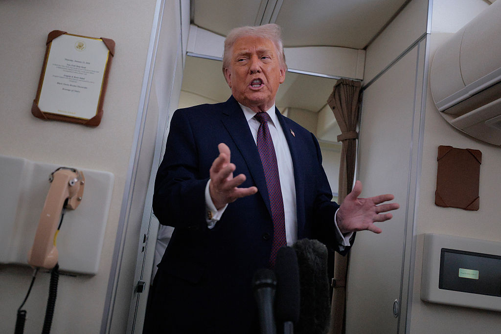 IN FLIGHT - JANUARY 22: U.S. President Donald Trump speaks to reporters on board Air Force One while flying in between Ireland and Washington as he returns from the World Economic Forum on January 22, 2026. Following a meeting with NATO Secretary General Mark Rutte, Trump announced a deal with European leaders on the semi-autonomous Danish territory of Greenland during the annual meeting of political and business leaders in Davos. (Photo by Chip Somodevilla/Getty Images)