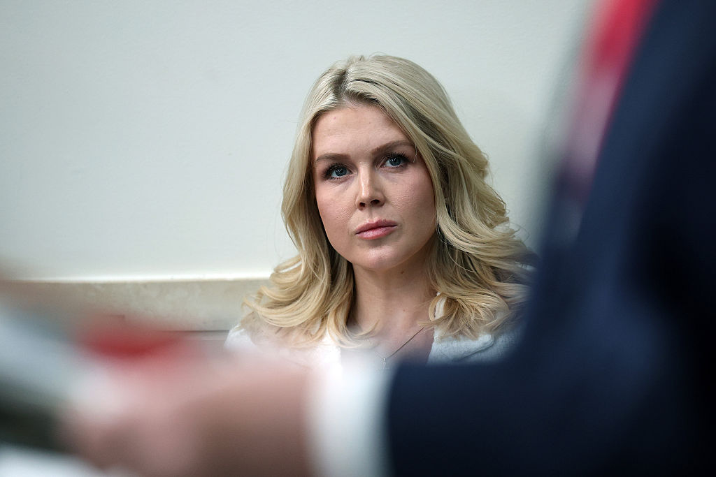 WASHINGTON, DC - JANUARY 20: White House Press Secretary Karoline Leavitt listens as U.S. President Donald Trump speaks during a press briefing in the James S. Brady Press Briefing Room of the White House on January 20, 2026 in Washington, DC. Leavitt was joined by President Trump days after the president threatened a 10% import tax on goods from eight European countries that have rallied around Denmark amid Trump's calls for the U.S. to take control of Greenland, a semi-autonomous Danish territory. (Photo by Win McNamee/Getty Images)