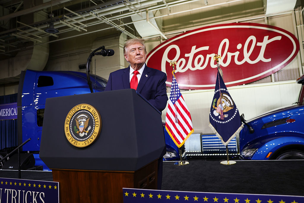 DENTON, TEXAS - OCTOBER 01: U.S. President Donald Trump stands at the podium during a visit to the Peterbilt Motors truck plant on October 01, 2026 in Denton, Texas. President Trump is kicking off a 32-day campaign blitz ahead of the midterm elections. Trump toured the factory and delivered remarks to workers during the visit to promote his administration’s economic and manufacturing agenda. (Photo by Kevin Dietsch/Getty Images)