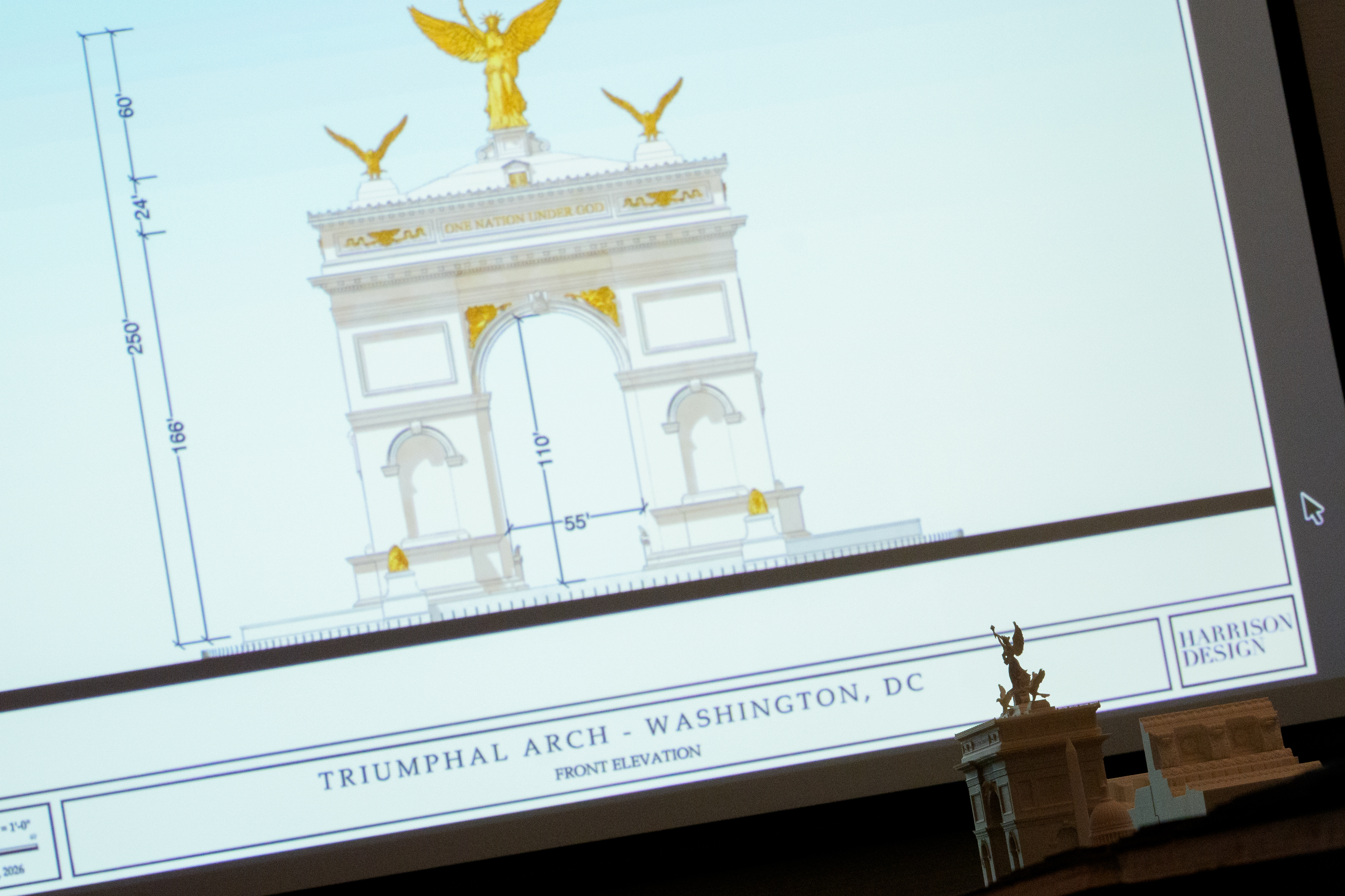 WASHINGTON, DC - APRIL 16: An image and model of President Donald Trump's proposed triumphal arch to commemorate the country's 250th anniversary are displayed during a public meeting of the Commission of Fine Arts at the National Building Museum on April 16, 2026 in Washington, DC. The Commission of Fine Arts voted unanimously to move forward with a proposed 250-foot arch informally dubbed the